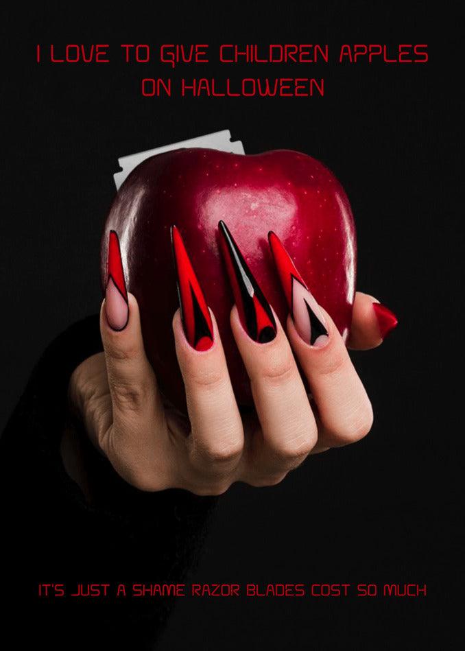 A hand holding a red Apple Funny Halloween Card, perfect for Halloween treats or Twisted Gifts.