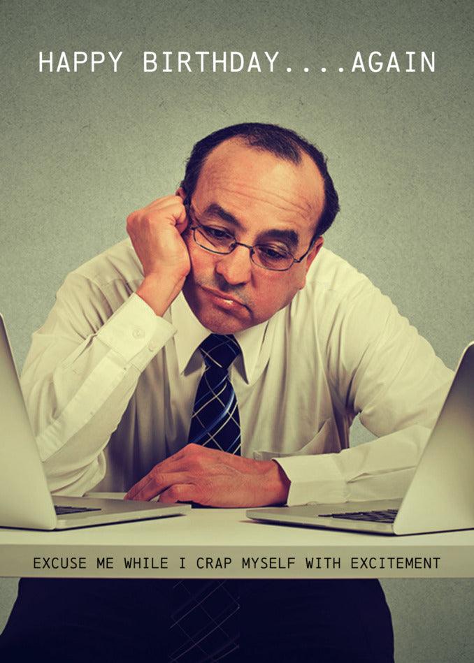 A man sitting at a desk with two laptops, enjoying a humorous Twisted Gifts Excitement Insulting Birthday Card.