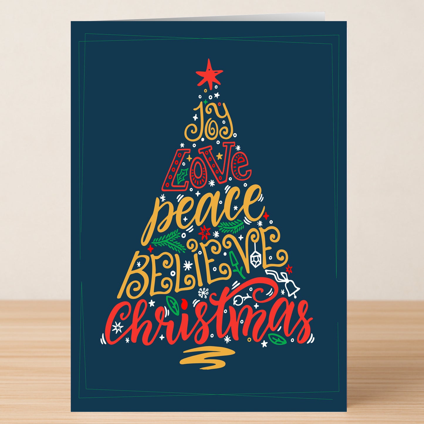 Share festive wishes with Twisted Gifts' Joy Tree Christmas Card, featuring a tree design shaped by "joy, love, peace, believe, Christmas" in vibrant text on a dark blue background—ideal for holiday celebrations.