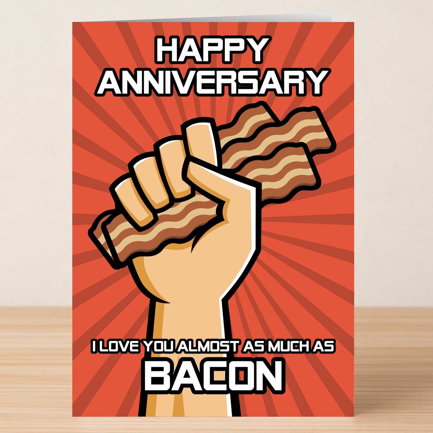 Add humor to your celebration with the Twisted Gifts Bacon Funny Anniversary Card—featuring a cartoon hand holding bacon and the message "Happy Anniversary. I love you almost as much as bacon" on a red background. Perfect for couples!.