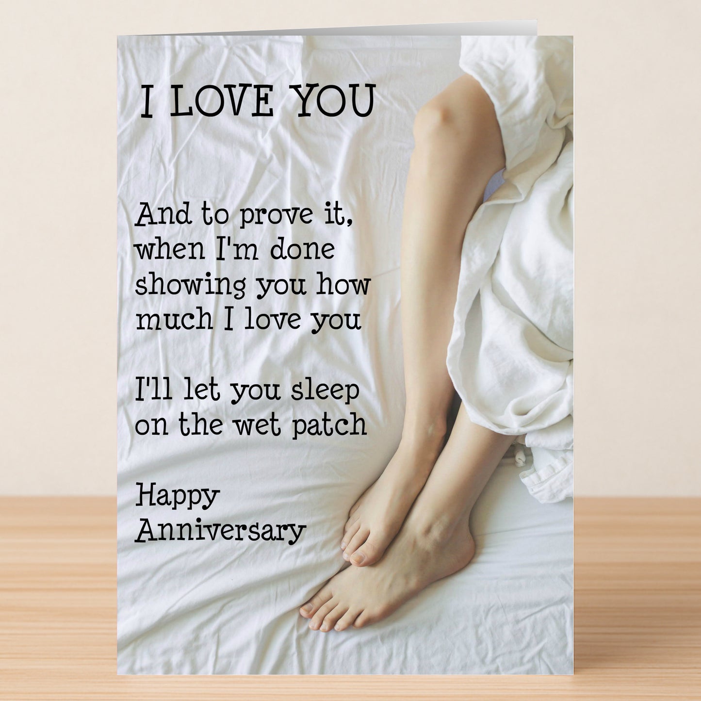 The Wet Patch Funny Anniversary Card by Twisted Gifts shows two pairs of bare feet on a white bed and reads "I LOVE YOU," making it a humorous pick for couples who enjoy laughter (and maybe the occasional wet patch).