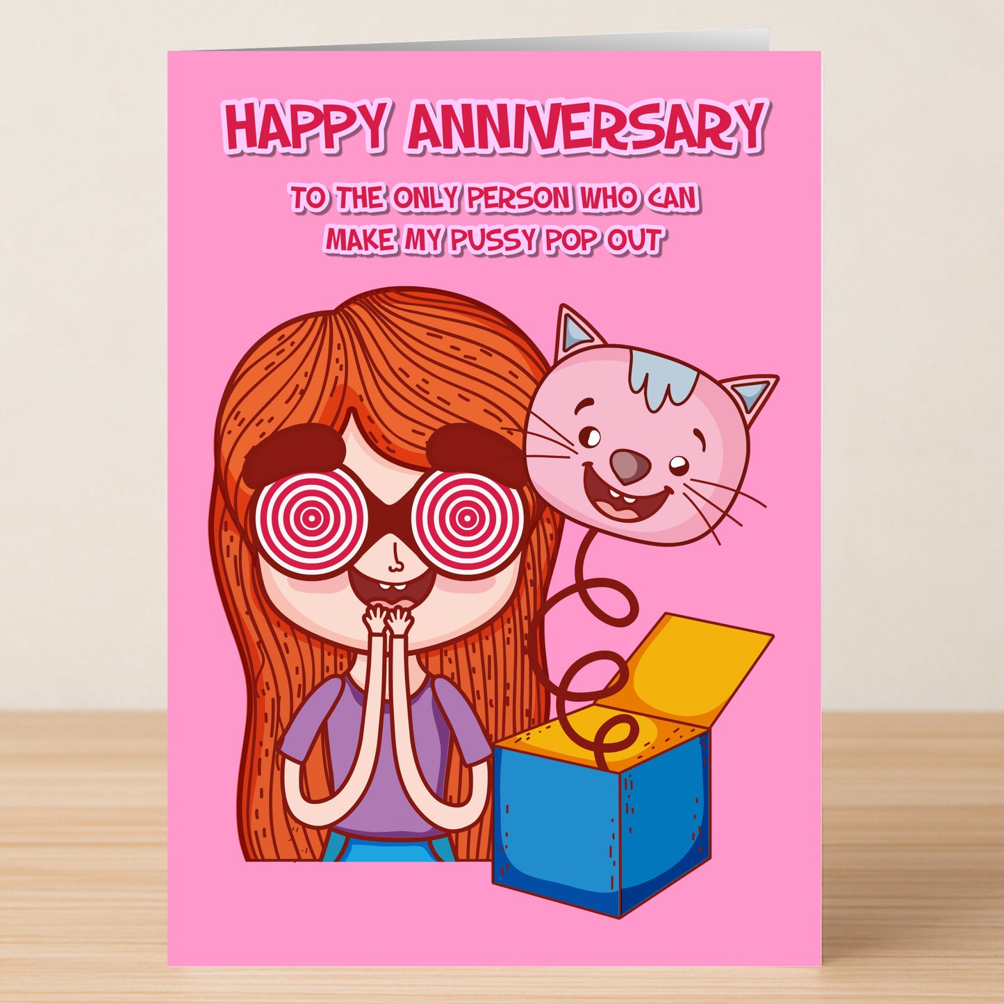 The Pop Out Funny Anniversary Card by Twisted Gifts features a cartoon woman with spiral eyes, surprised face, and a cat jumping from a box. Front text: “Happy Anniversary. To the only person who can make my pussy pop out.”.