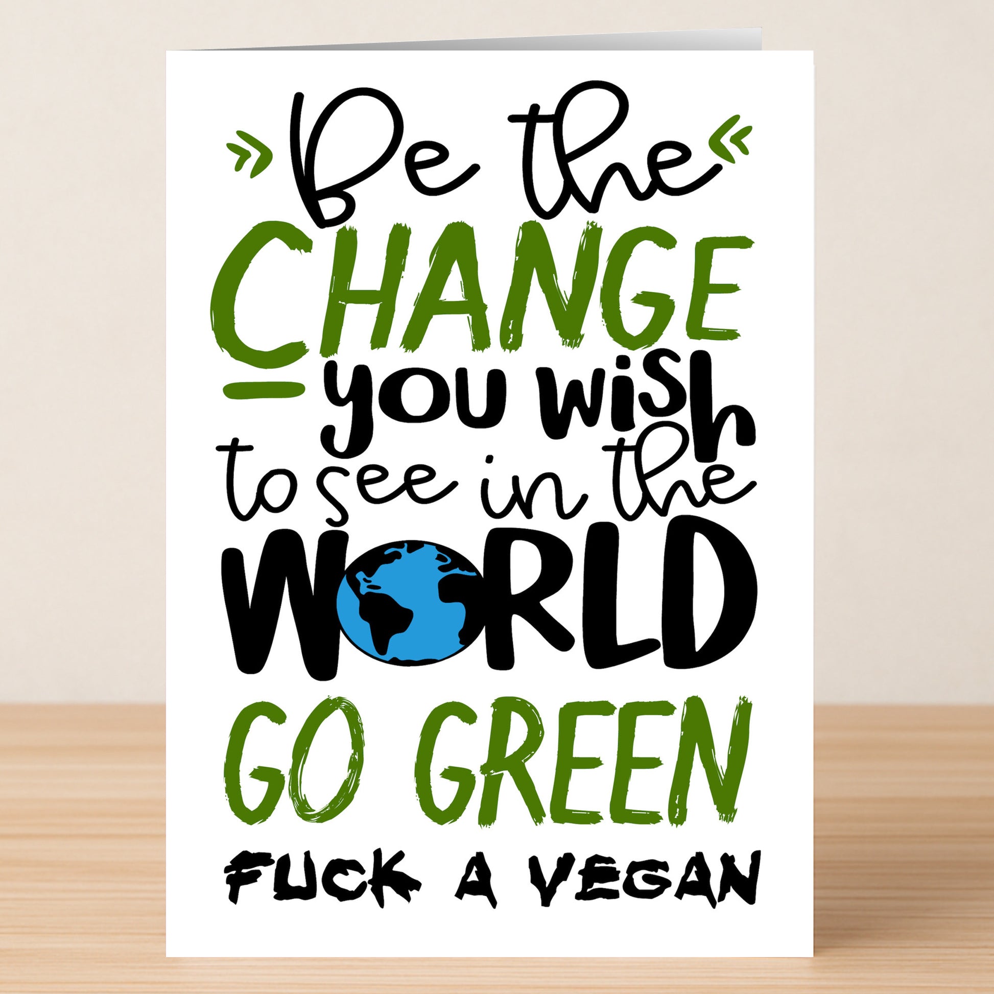 The Go Green Rude Greeting Card by Twisted Gifts features the cheeky message: "Be the change you wish to see in the world. Go green. Fuck a vegan," making it a bold, eco-friendly pick for anyone with an irreverent sense of humor.