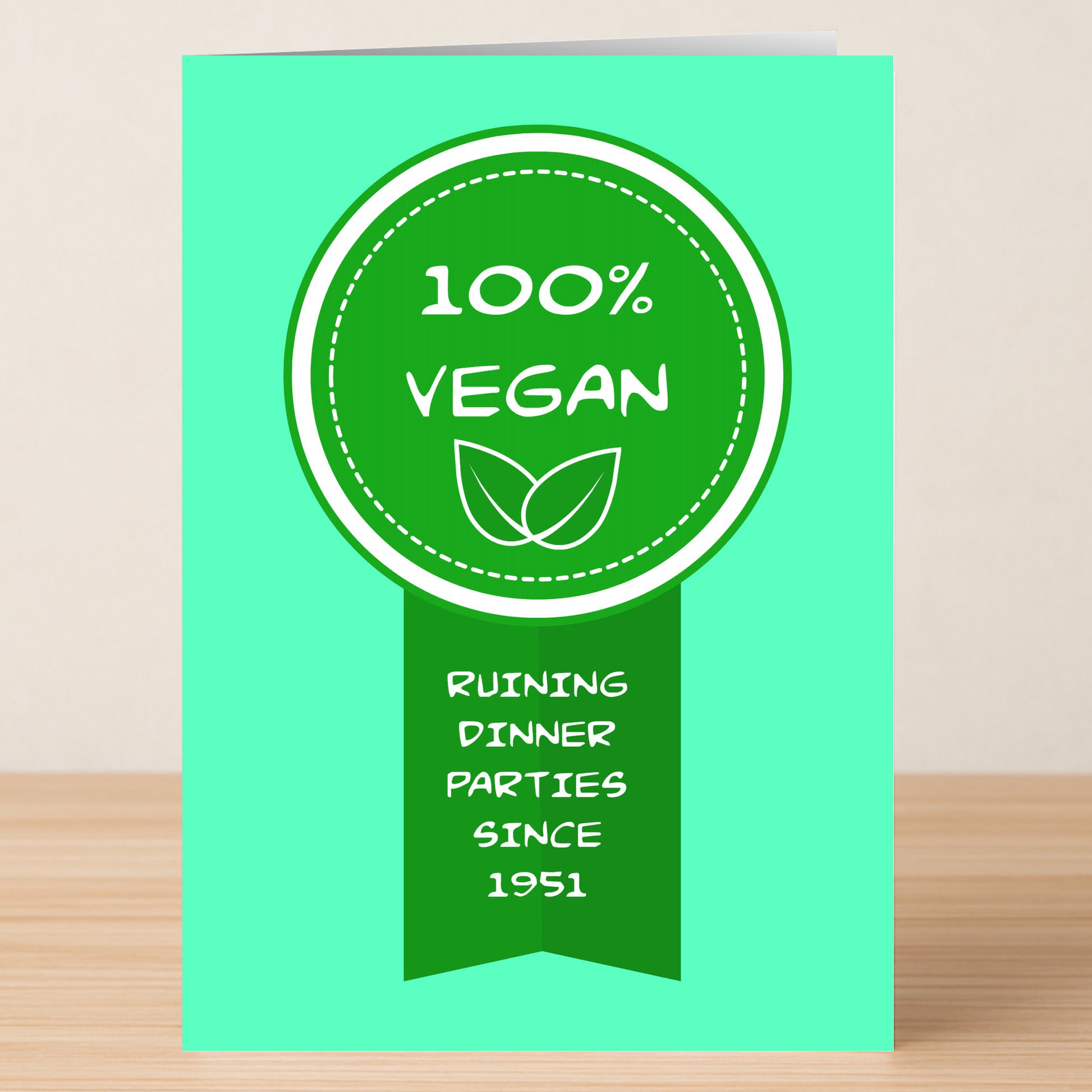 The Dinner Parties Funny Greeting Card by Twisted Gifts features a green card with a "100% Vegan" badge, two leaf icons, and the slogan "Ruining dinner parties since 1951"—an ideal choice for anyone who loves humorous cards.