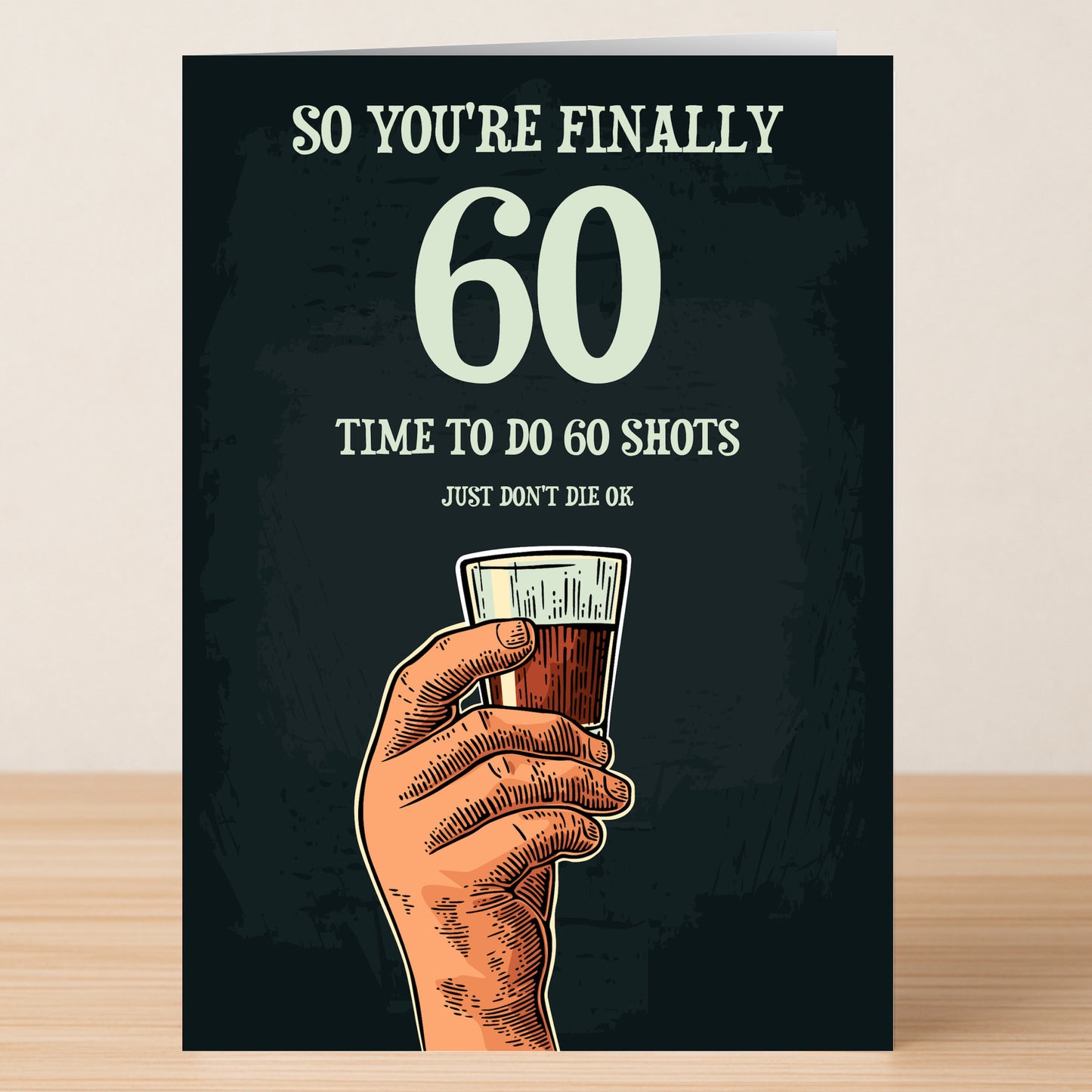 Twisted Gifts’ "Shots – Funny 60th Birthday Card" features a hand with a shot glass and the message: “So you’re finally 60, time to do 60 shots, just don’t die ok.” Ideal for anyone who loves sarcastic birthday cards!.