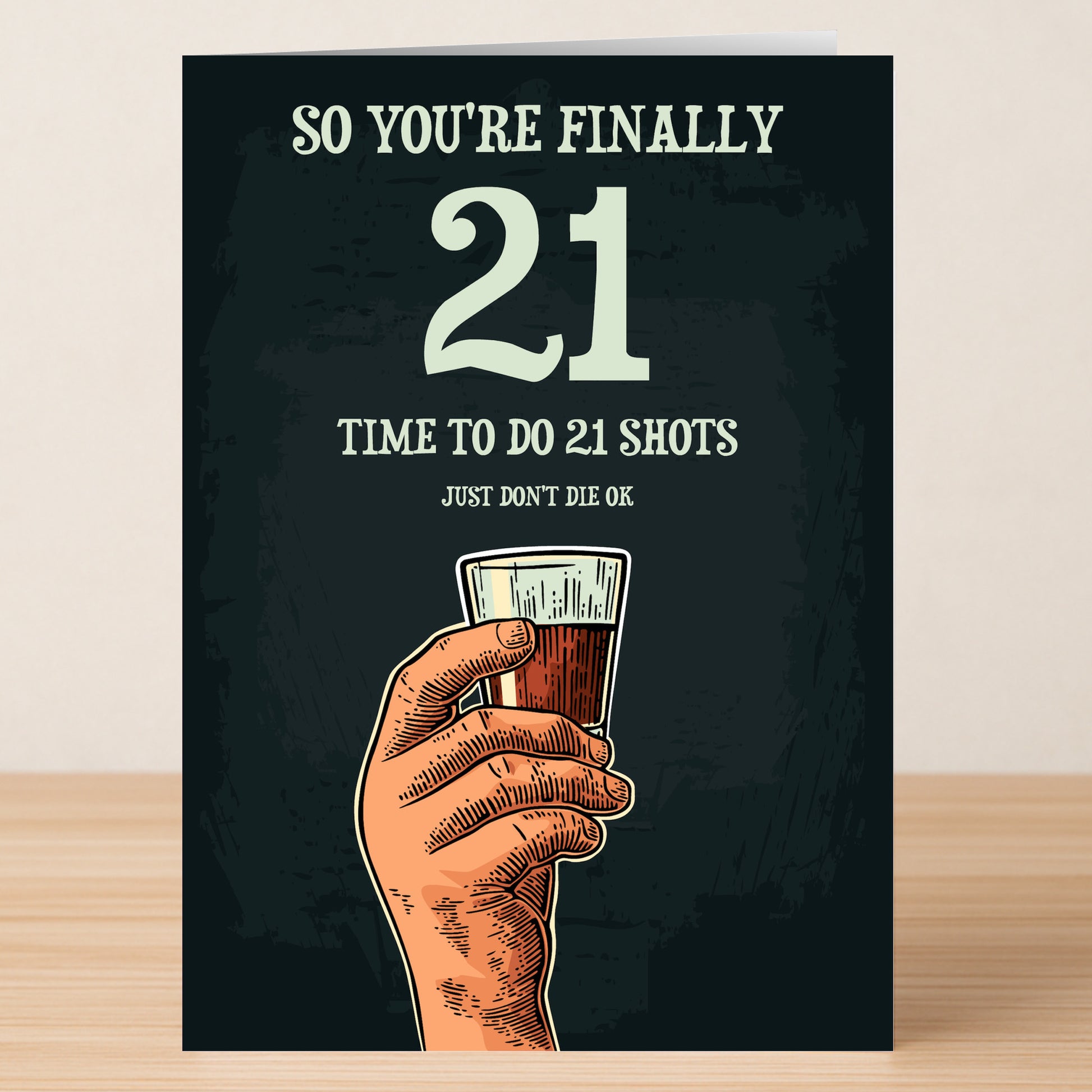 The Twisted Gifts 21 - Shots 21 Funny Birthday Card features a hand holding a shot glass and the message, "So you're finally 21. Time to do 21 shots. Just don't die ok"—a perfect way to celebrate this milestone birthday.