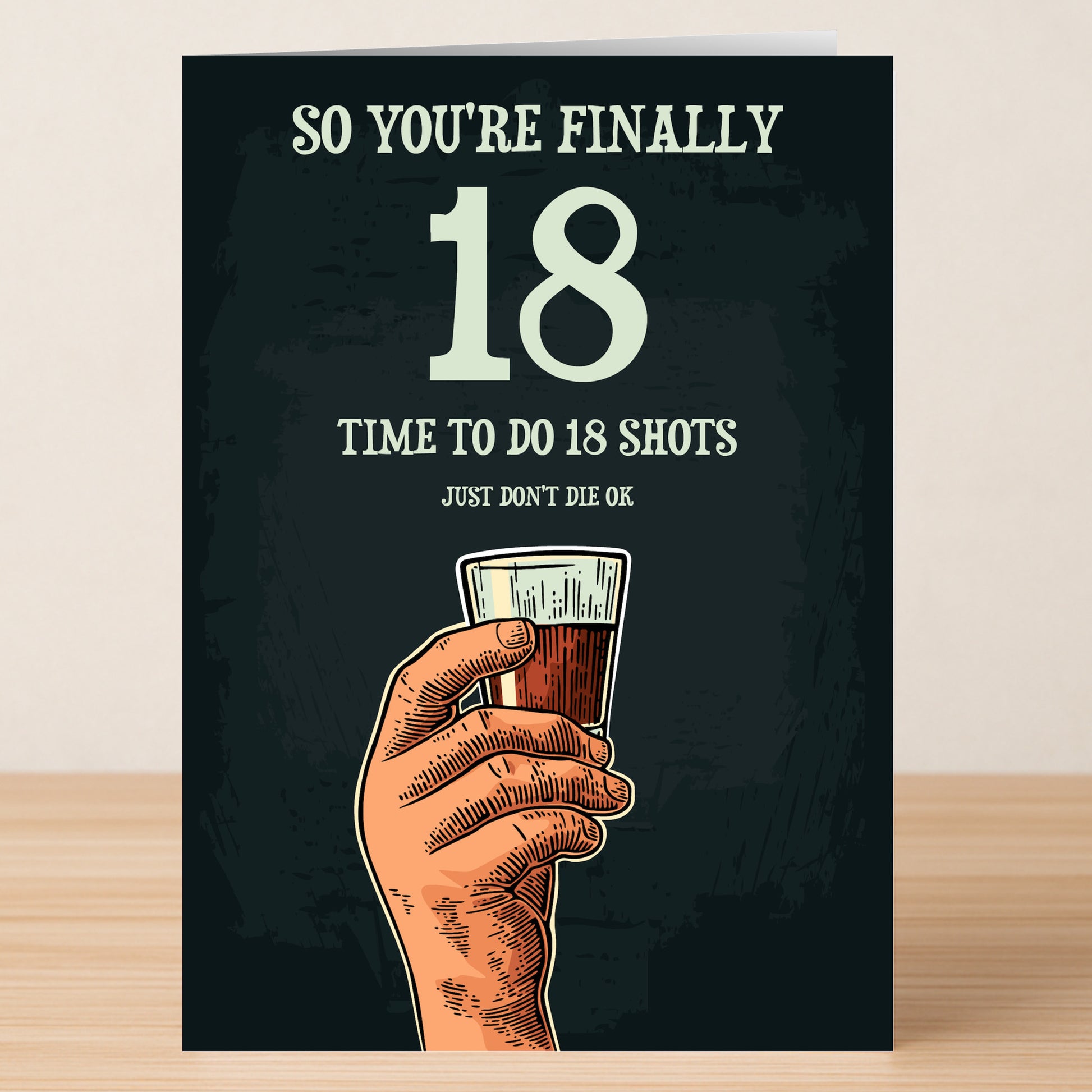 Celebrate turning 18 with the Twisted Gifts "18 - Shots 18 Funny Birthday Card," featuring a hand holding a shot glass and the message, "So you're finally 18. Time to do 18 shots. Just don't die ok." Perfect for birthday laughs!.