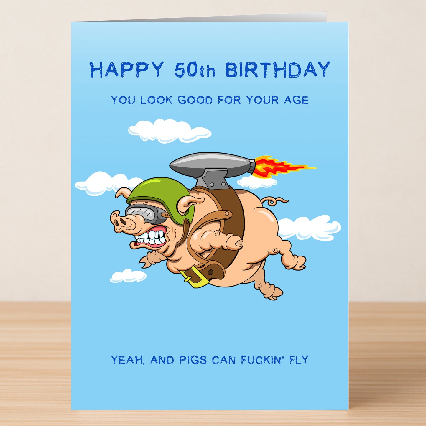 Celebrate their milestone with the Twisted Gifts "Pigs Can Fly – Insulting 50th Birthday Card," featuring a cartoon pig in a helmet and jetpack with the cheeky greeting: "Happy 50th Birthday. Yeah, and pigs can fuckin’ fly.