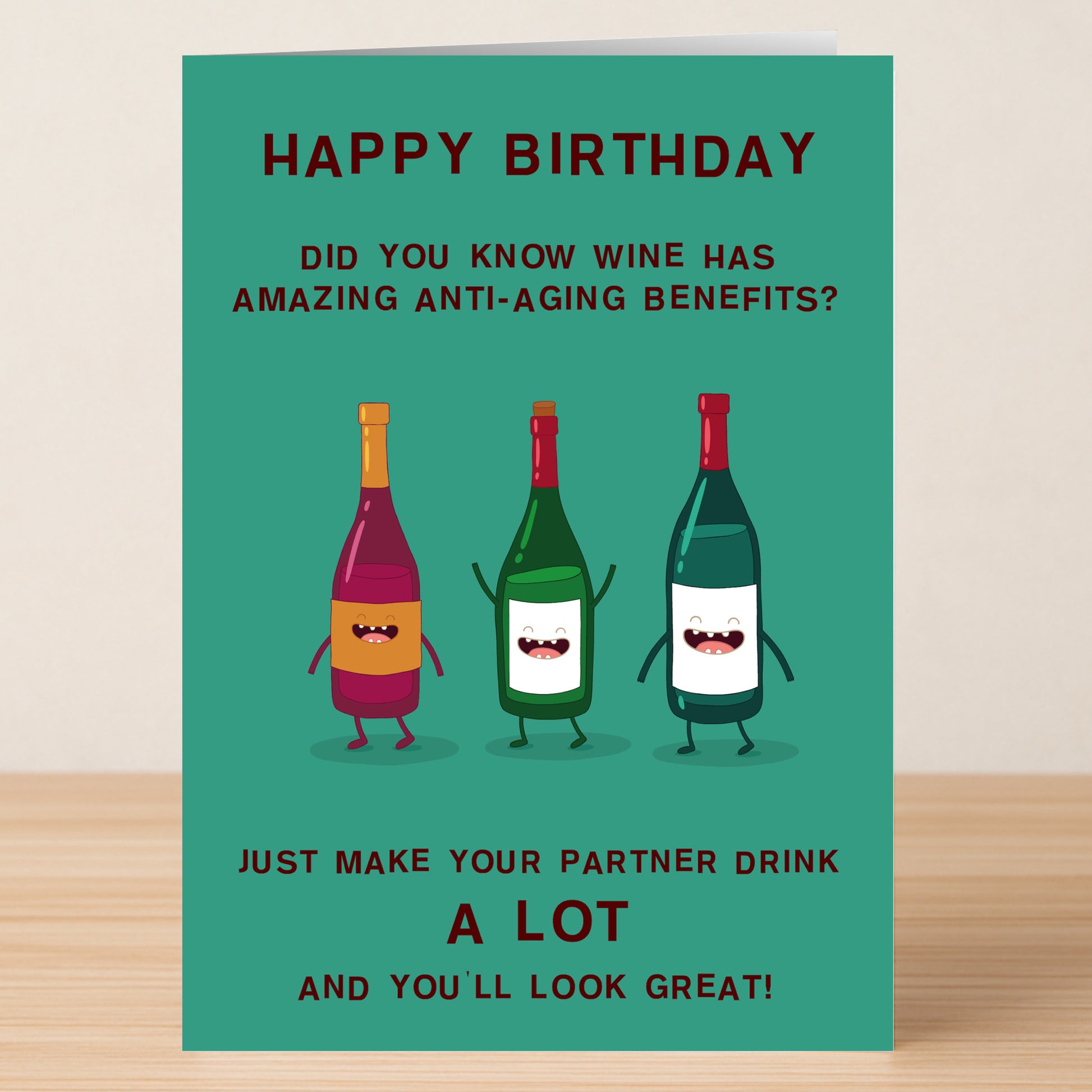 The Anti-aging Funny Birthday Card by Twisted Gifts features three cartoon wine bottles with arms and faces, plus a witty birthday message about wine’s anti-aging benefits—perfect for your partner’s special day.
