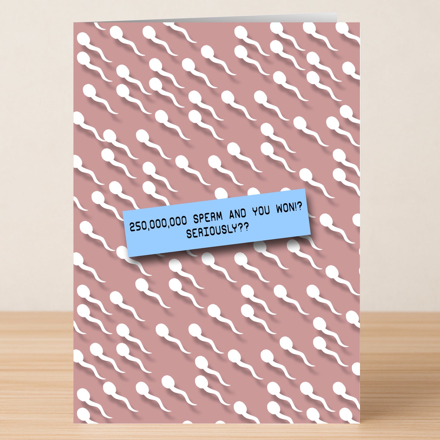 The Sperm, Seriously? Rude Birthday Card by Twisted Gifts features white sperm illustrations on a pink background and the funny message: “250,000,000 sperm and you won!? Seriously??”.