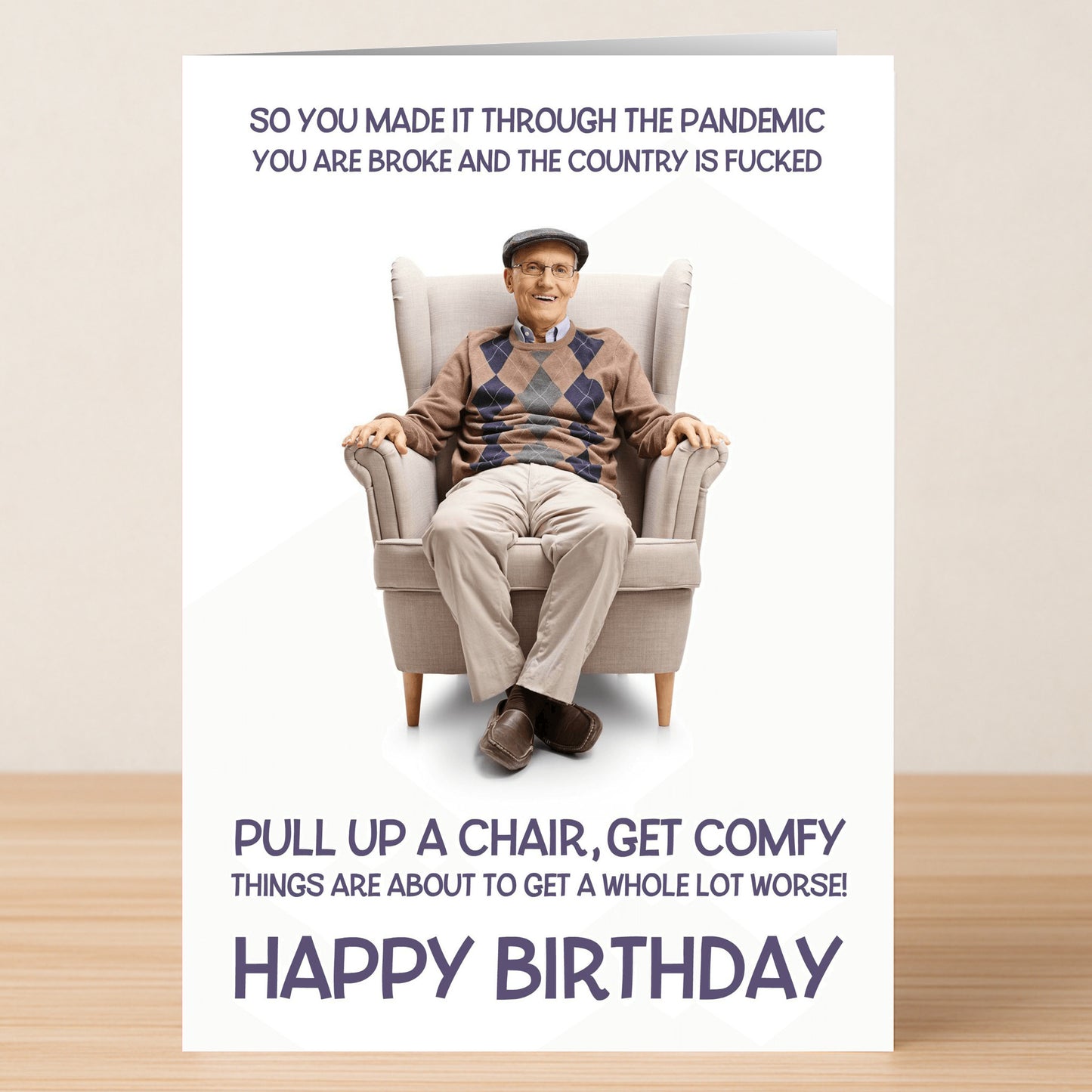 The Get Comfy Funny Birthday Card by Twisted Gifts shows an older man in an armchair with pandemic humor, jokes about tough times, and a cheerful "Happy Birthday" message at the bottom.