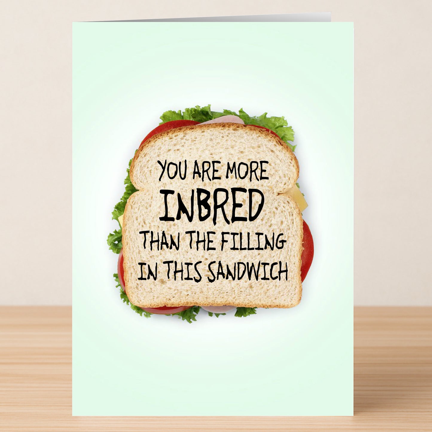The Inbread Funny Birthday Card by Twisted Gifts features a sandwich and the joke "You are more inbred than the filling in this sandwich." It's a hilarious way to make someone's birthday extra special!.