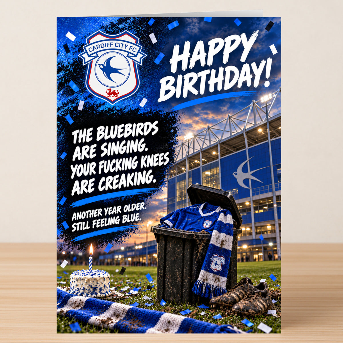 Cardiff City – Funny Birthday Card featuring a stadium, a bin with a blue jersey and scarf, and the text: “Happy Birthday! The Bluebirds are singing. Your fucking knees are creaking.”