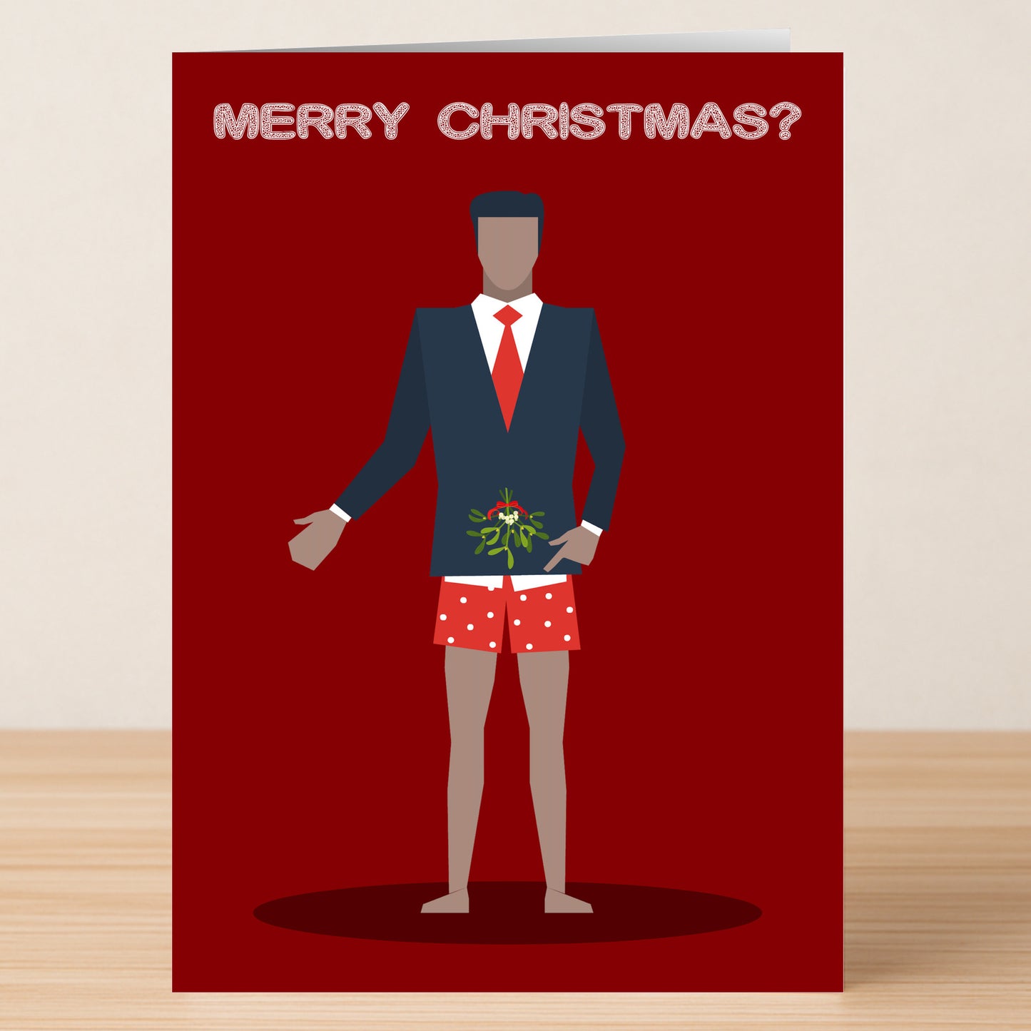 The Merry Christmas Rude Christmas Card by Twisted Gifts features a suited man with a red tie and polka-dot boxers holding mistletoe, "Merry Christmas?" above him—a cheeky holiday card great for festive laughs.