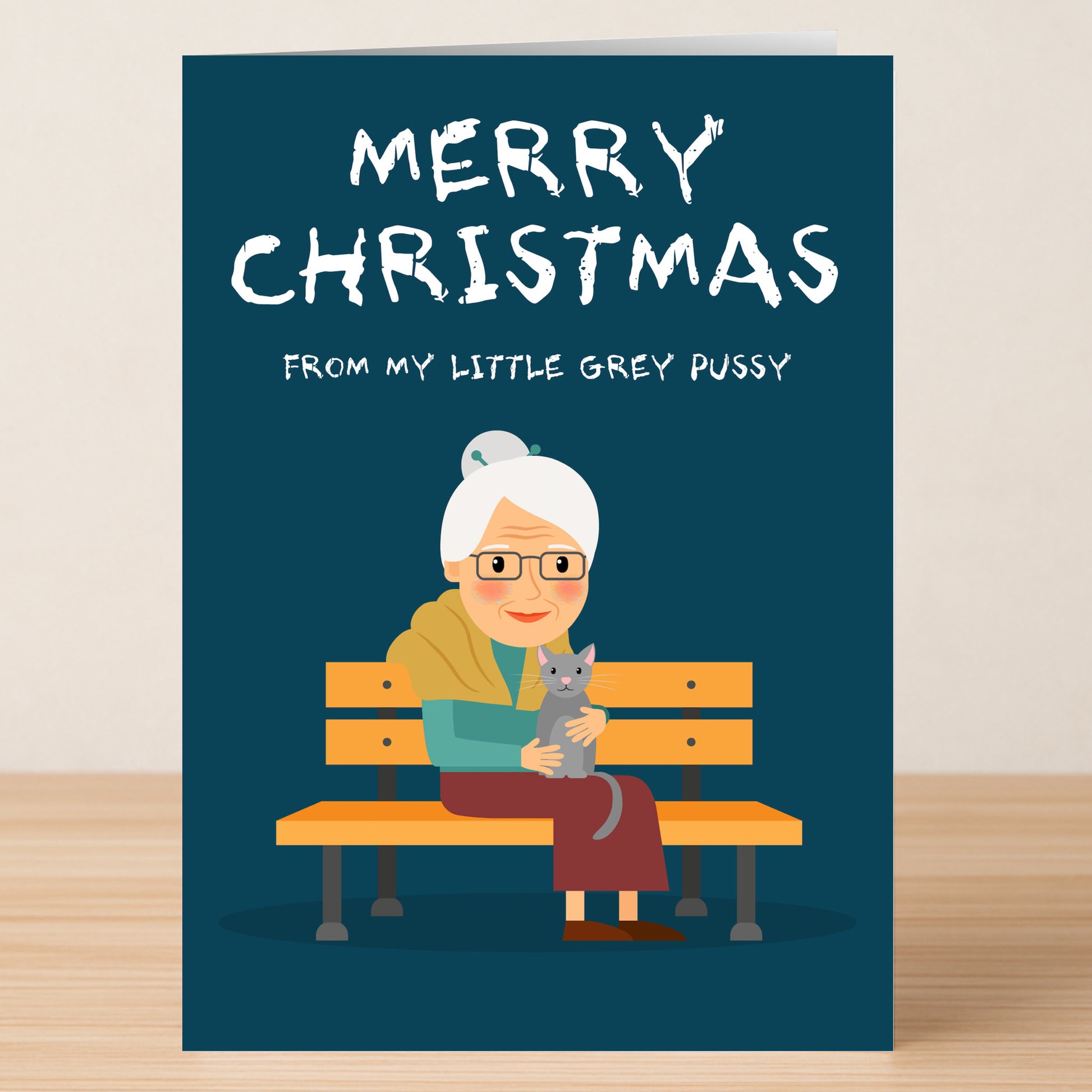 The Grey Pussy Rude Christmas Card by Twisted Gifts features a funny illustration of an elderly woman with glasses and a grey cat, plus the cheeky message: "Merry Christmas from my little grey pussy.