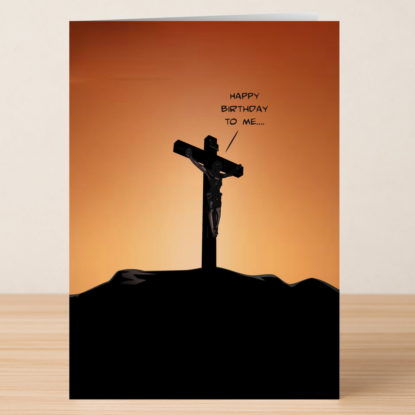 The Happy Birthday To Me Funny Christmas Card by Twisted Gifts features a silhouette of Jesus on the cross at sunset with a speech bubble saying, "Happy birthday to me…"—perfect for adding unexpected holiday cheer.