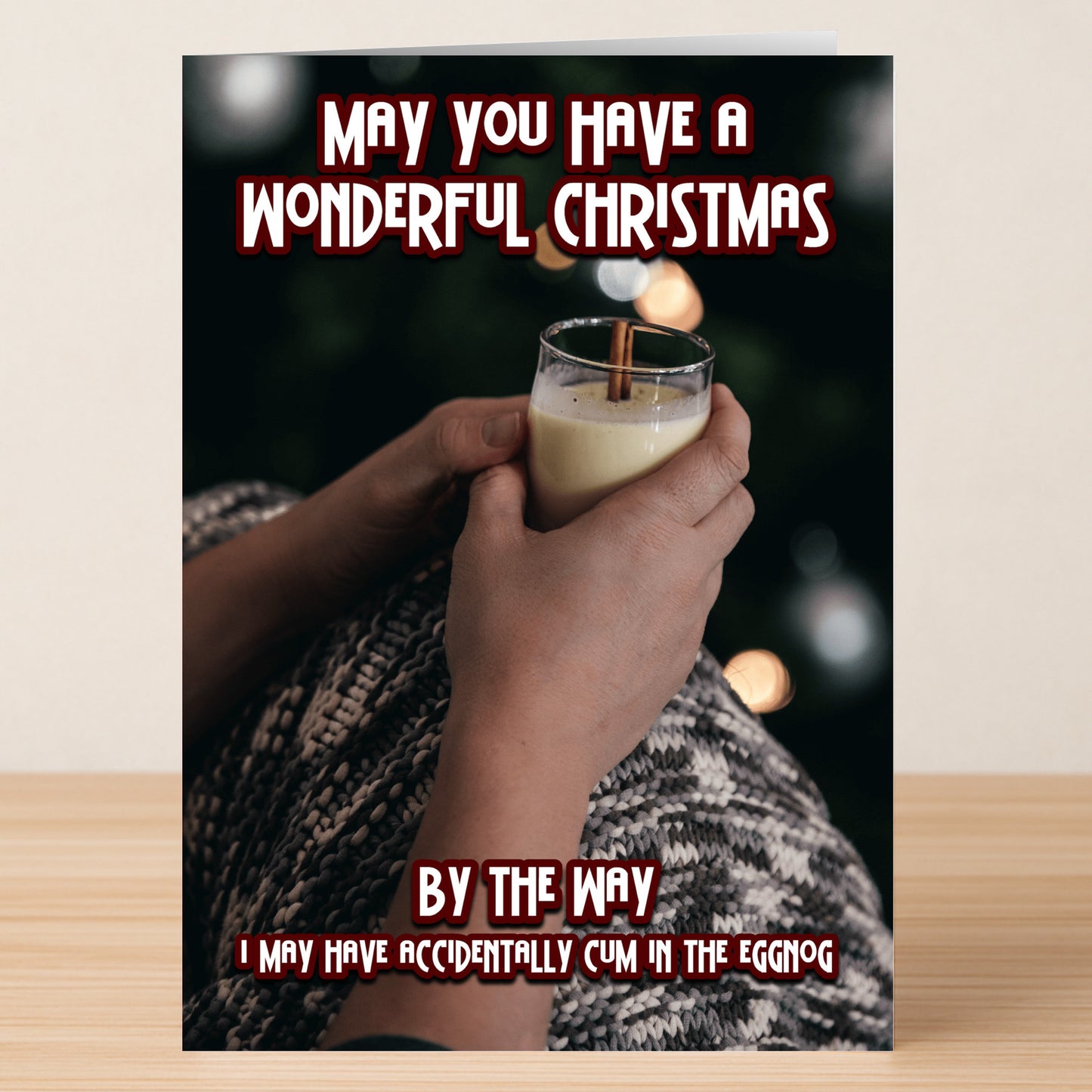 Snuggled in a blanket with eggnog and a cinnamon stick, someone shares a Twisted Gifts Eggnog Rude Christmas Card—filled with hilarious, explicit text to add laughter to the holidays.