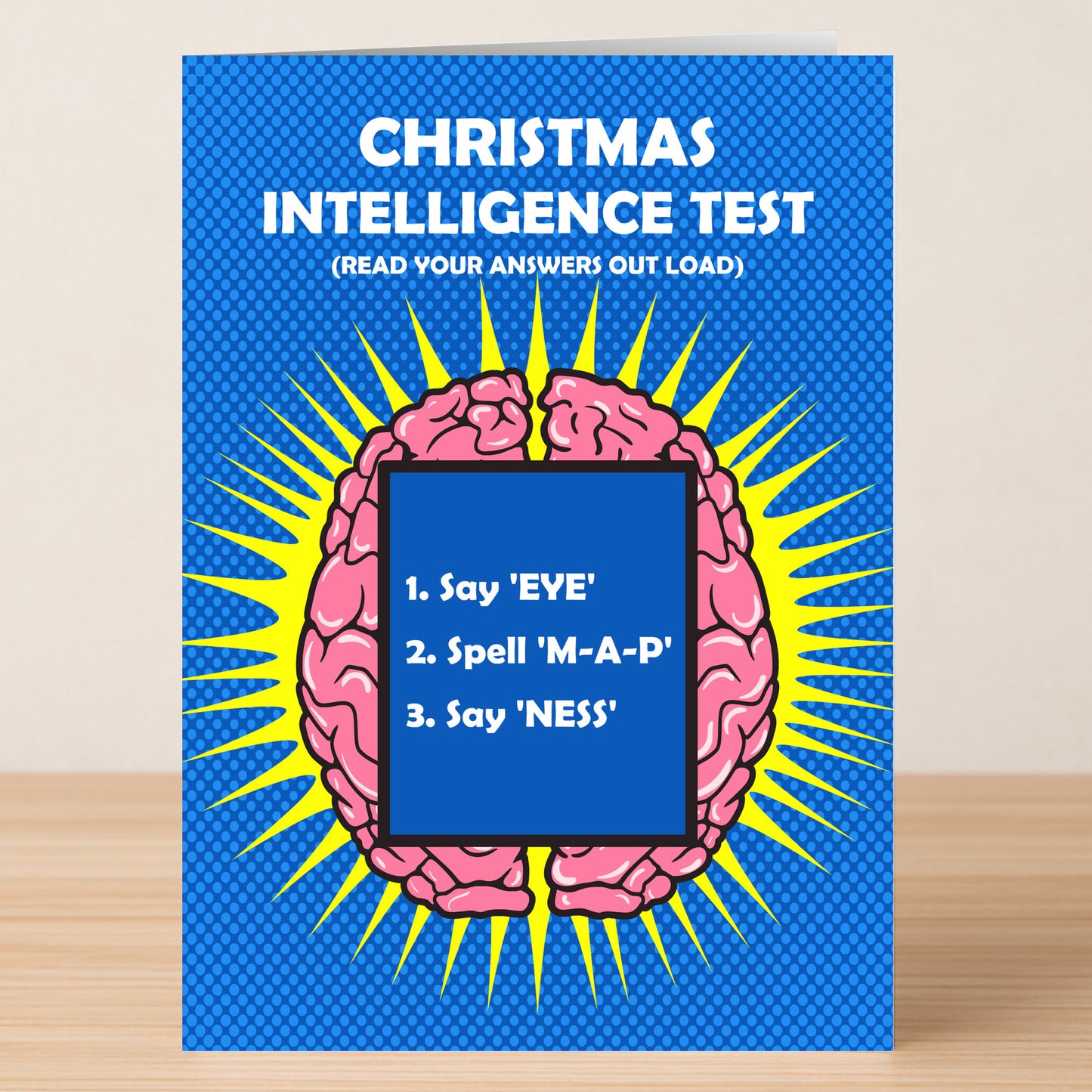 The Twisted Gifts Intelligence Insulting Christmas Card features a cartoon brain and the title "Christmas Intelligence Test," humorously challenging readers with three playful tasks.