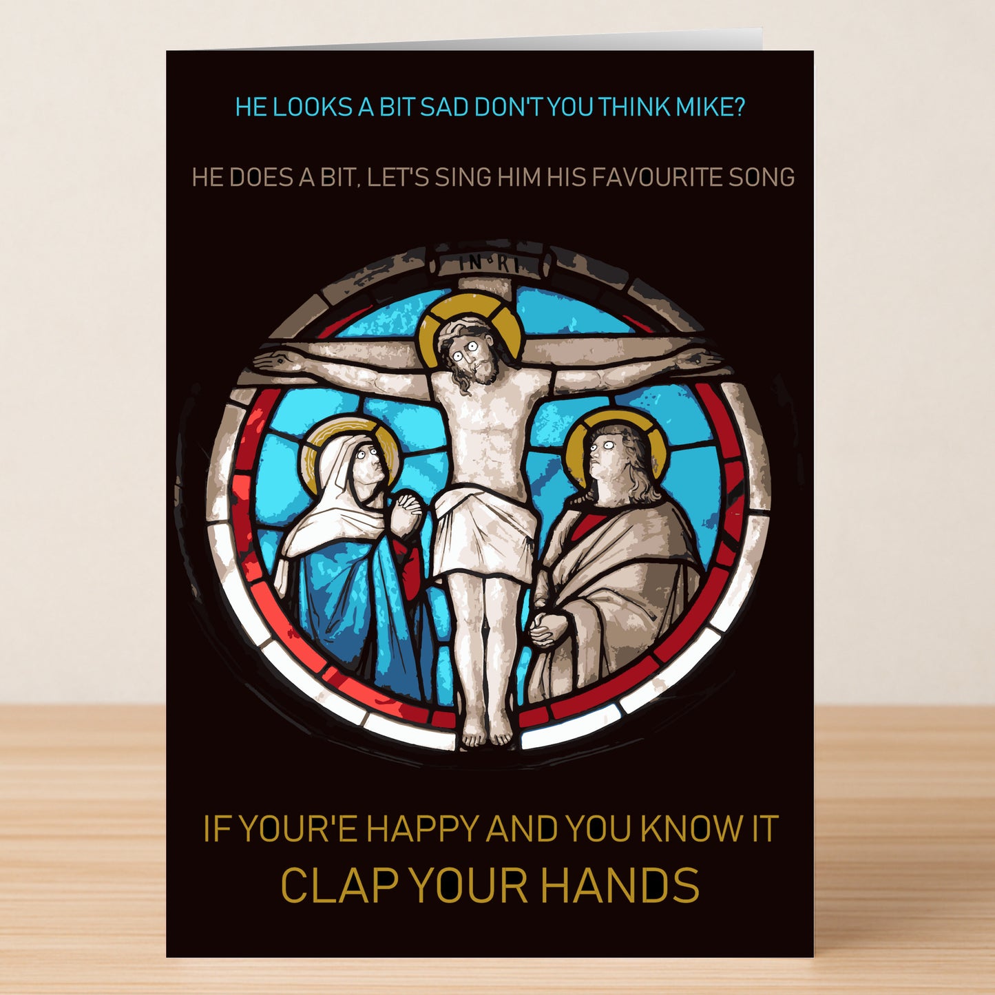 The Clap Your Hands Funny Christmas Card by Twisted Gifts features a stained glass crucifixion image and witty "If You're Happy and You Know It, Clap Your Hands" text—perfect for adding humor to your holiday celebration.