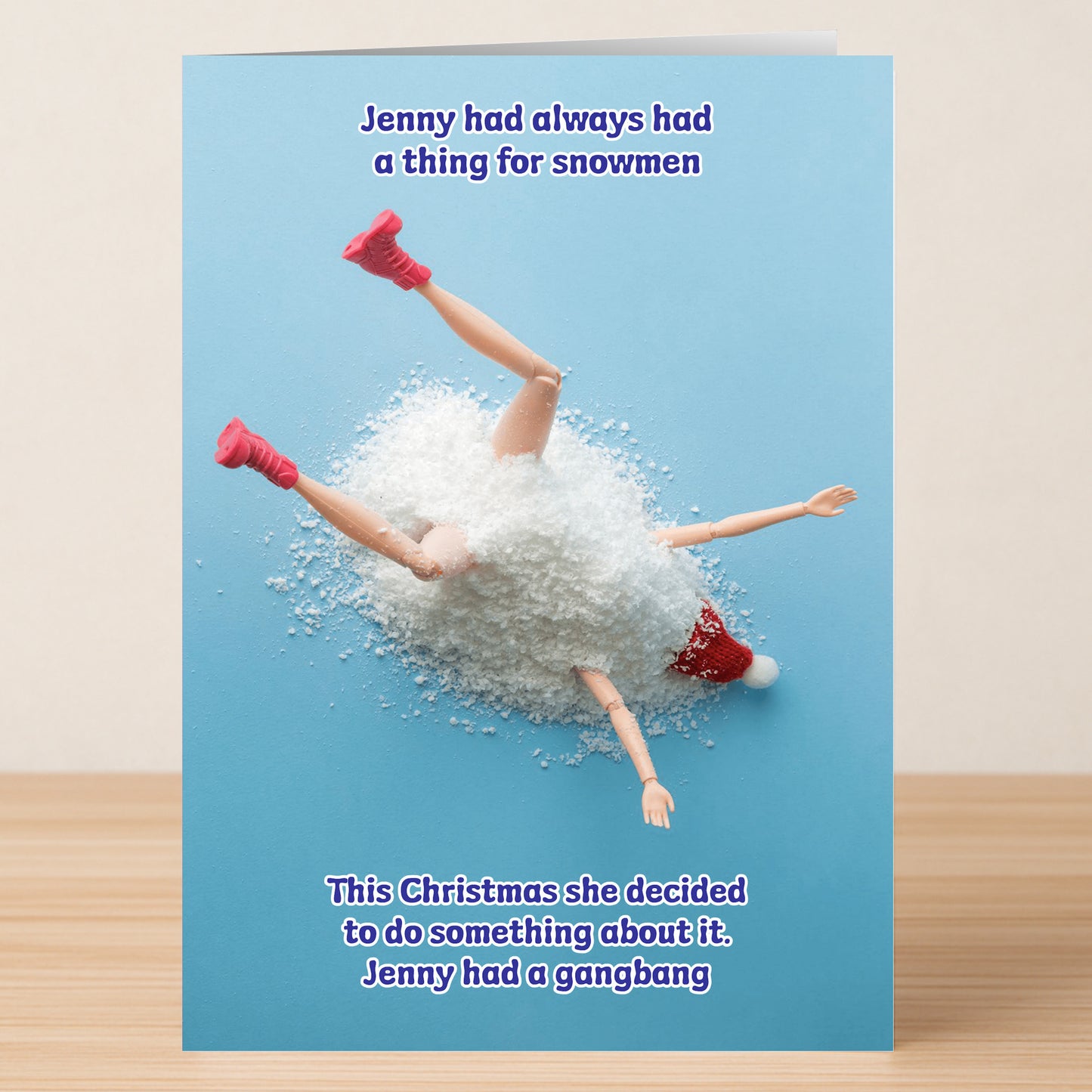 The Snowmen Rude Christmas Card by Twisted Gifts features a funny holiday scene with a toy doll in fake snow, hinting at Jenny’s cheeky Christmas mischief with snowmen.