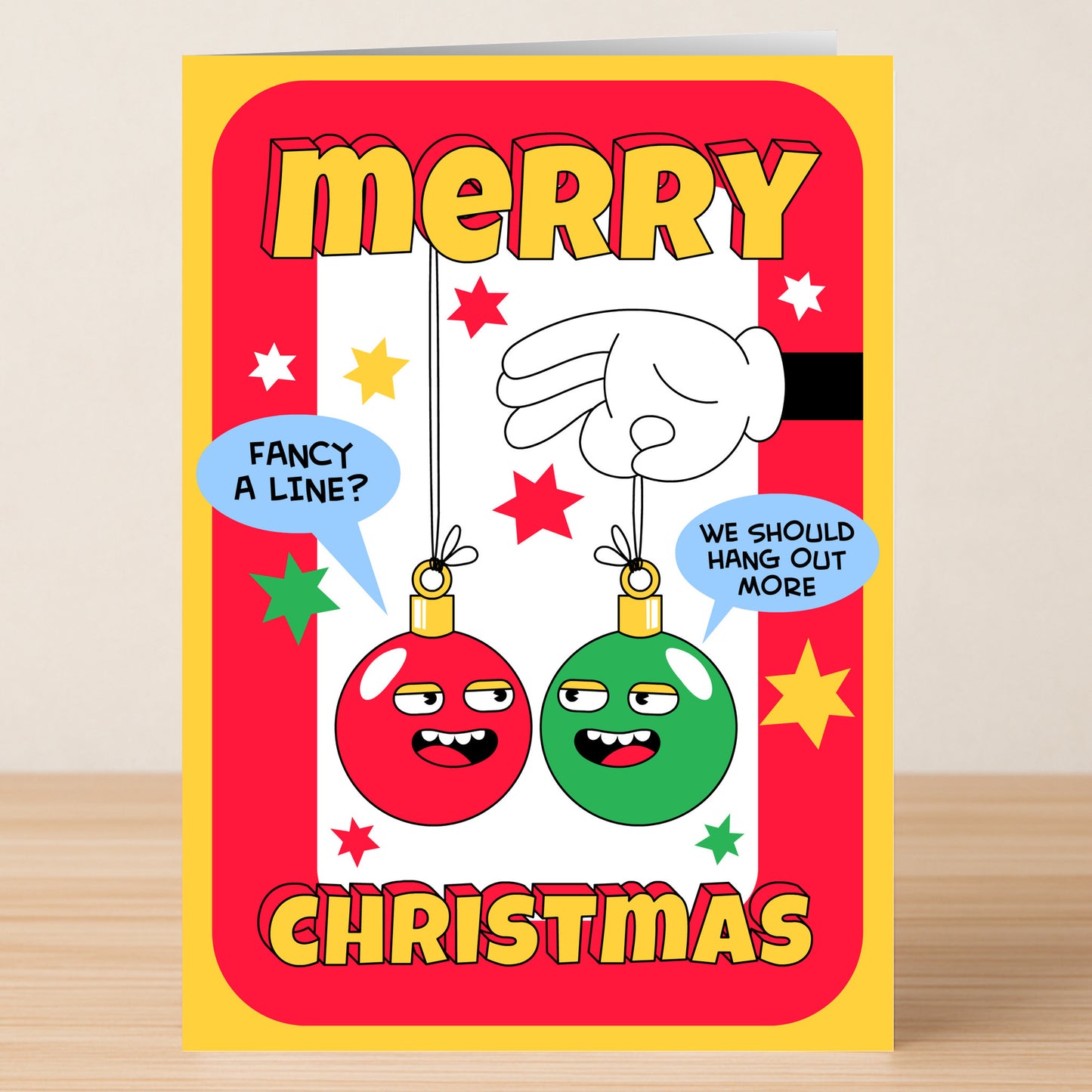 The Hangout Funny Christmas Card by Twisted Gifts features cartoon red and green baubles with speech bubbles and "Merry Christmas" in bold yellow on a red border—ideal for sharing holiday cheer with a humorous twist.