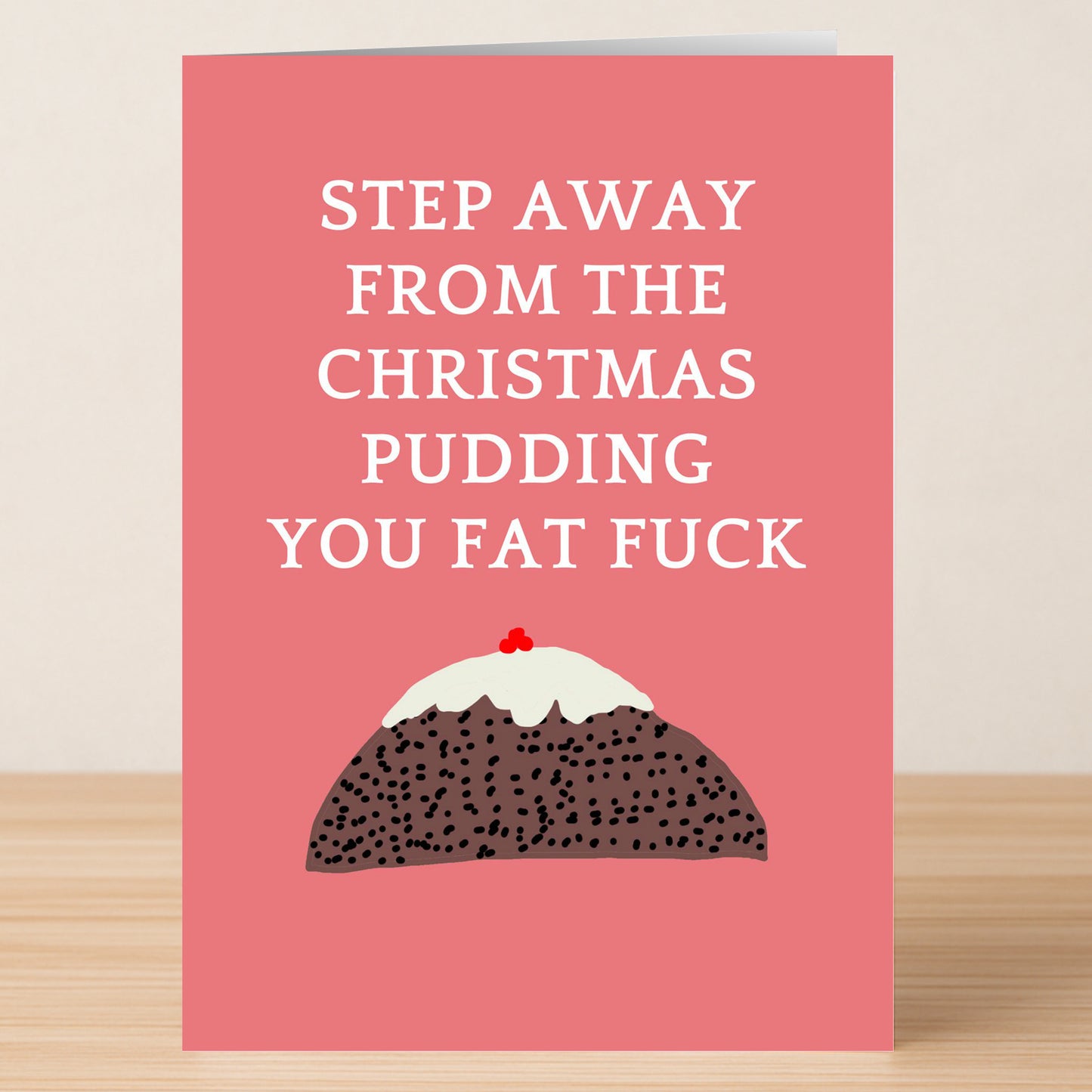 The Pudding Funny Christmas Card by Twisted Gifts features the text "STEP AWAY FROM THE CHRISTMAS PUDDING YOU FAT FUCK" above a festive pudding on a pink background—perfect for sharing bold, humorous holiday cheer.