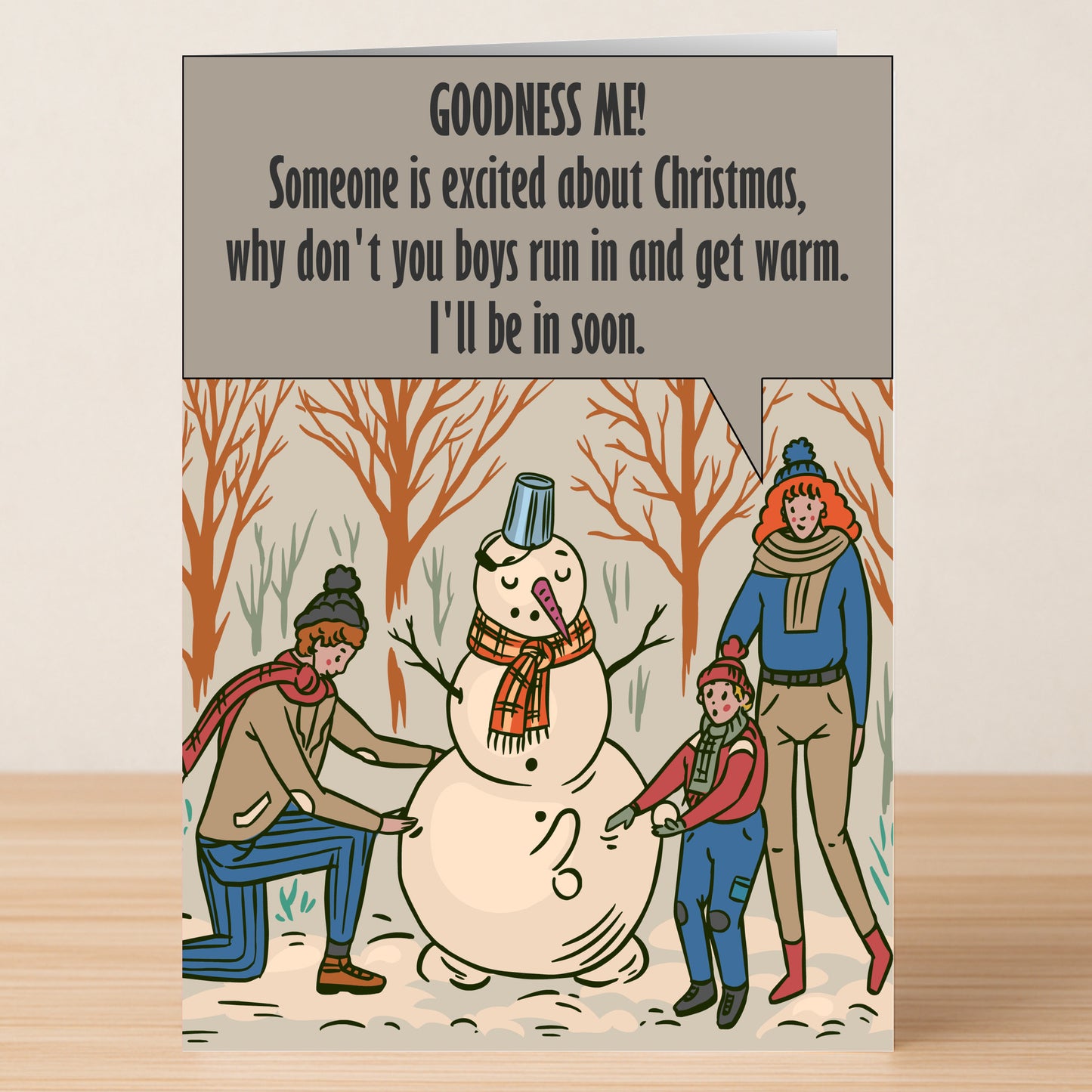 The Goodness Me Funny Christmas Card by Twisted Gifts features two adults and a child building a snowman outdoors, with a speech bubble joke—ideal for a lighthearted Christmas greeting.