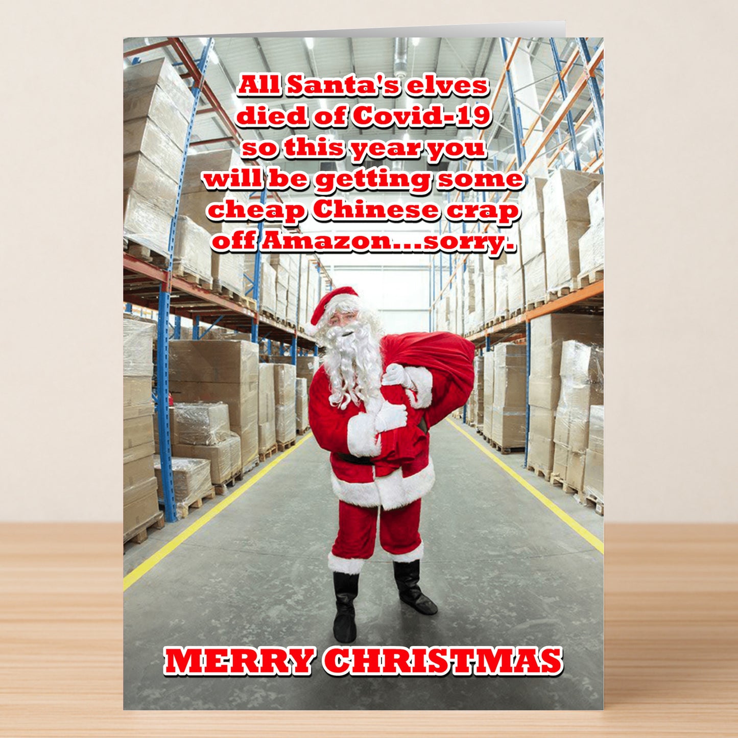 A person dressed as Santa stands in a warehouse aisle with boxes. Text jokes about Covid-19 supply issues and Amazon—making this Twisted Gifts "Amazon Funny Christmas Card" the perfect pick for laughs this holiday season.