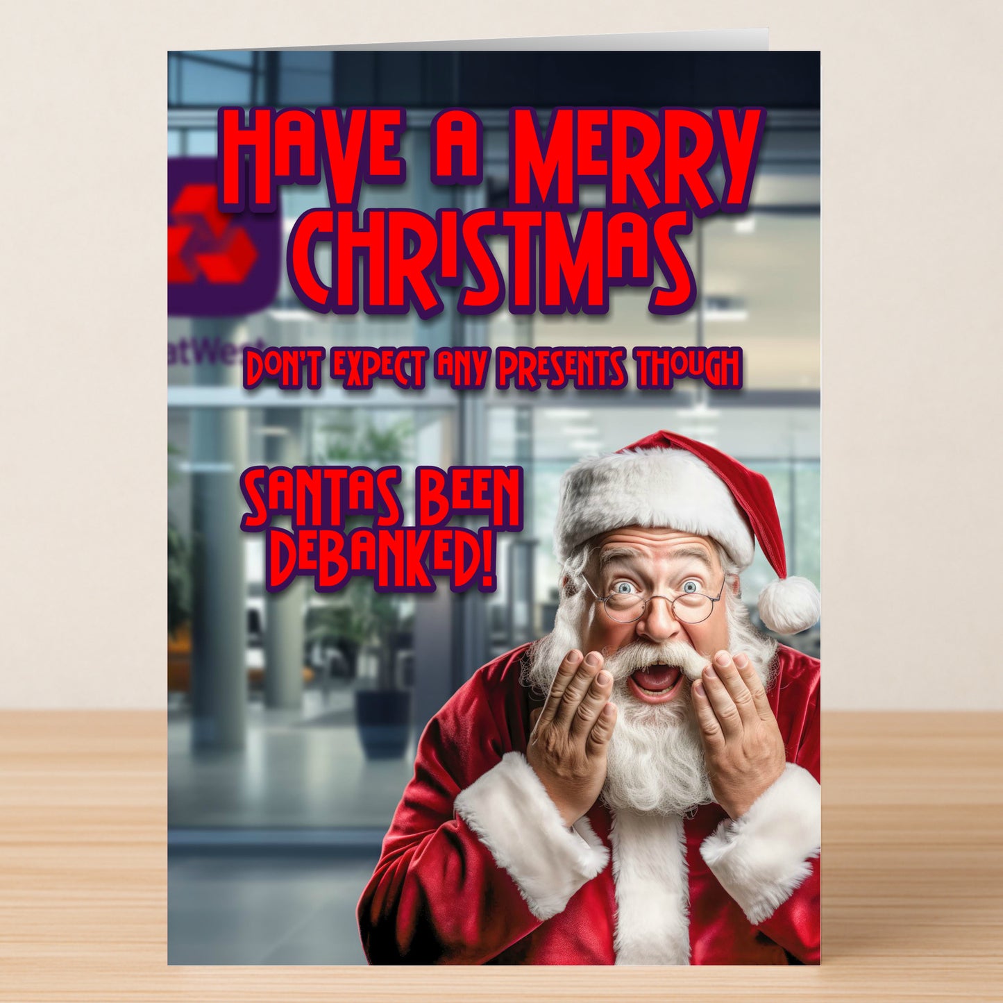 A surprised Santa holds his cheeks before a blurred bank scene. Text: "Have a Merry Christmas. Don't expect any presents though. Santa's been debanked!" A humorous Debanked Funny Christmas Card by Twisted Gifts.