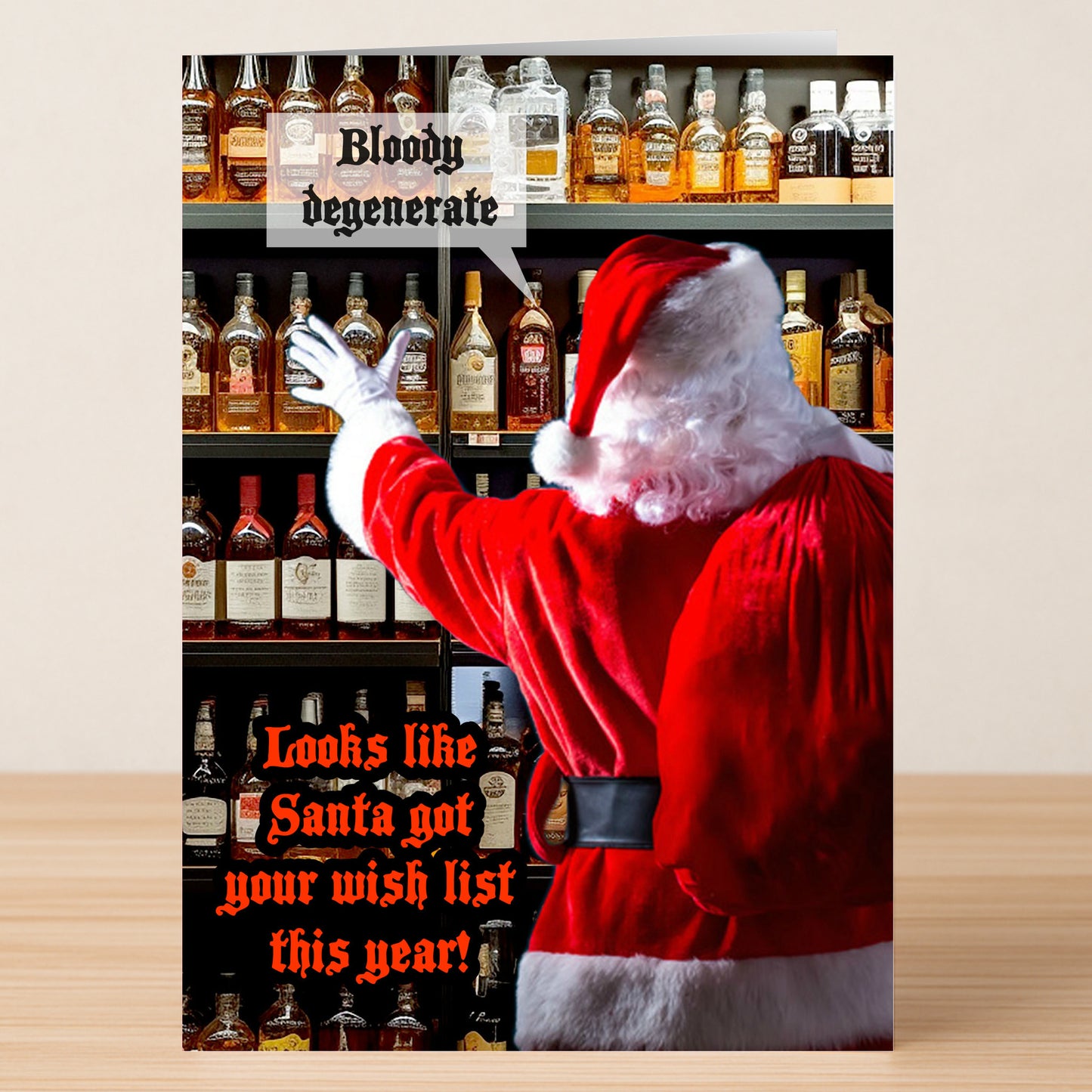 Santa grabs a bottle from a liquor shelf beside the text “Bloody degenerate” and “Looks like Santa got your wish list this year!” Degenerate Funny Christmas Card by Twisted Gifts is the perfect holiday humor card.