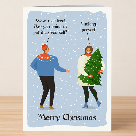 A man in a Christmas sweater asks a woman with a decorated tree if she's putting it up herself; she replies with a witty insult. "Nice Tree" and "Merry Christmas" add cheer to this Twisted Gifts Nice Tree Funny Christmas Card.
