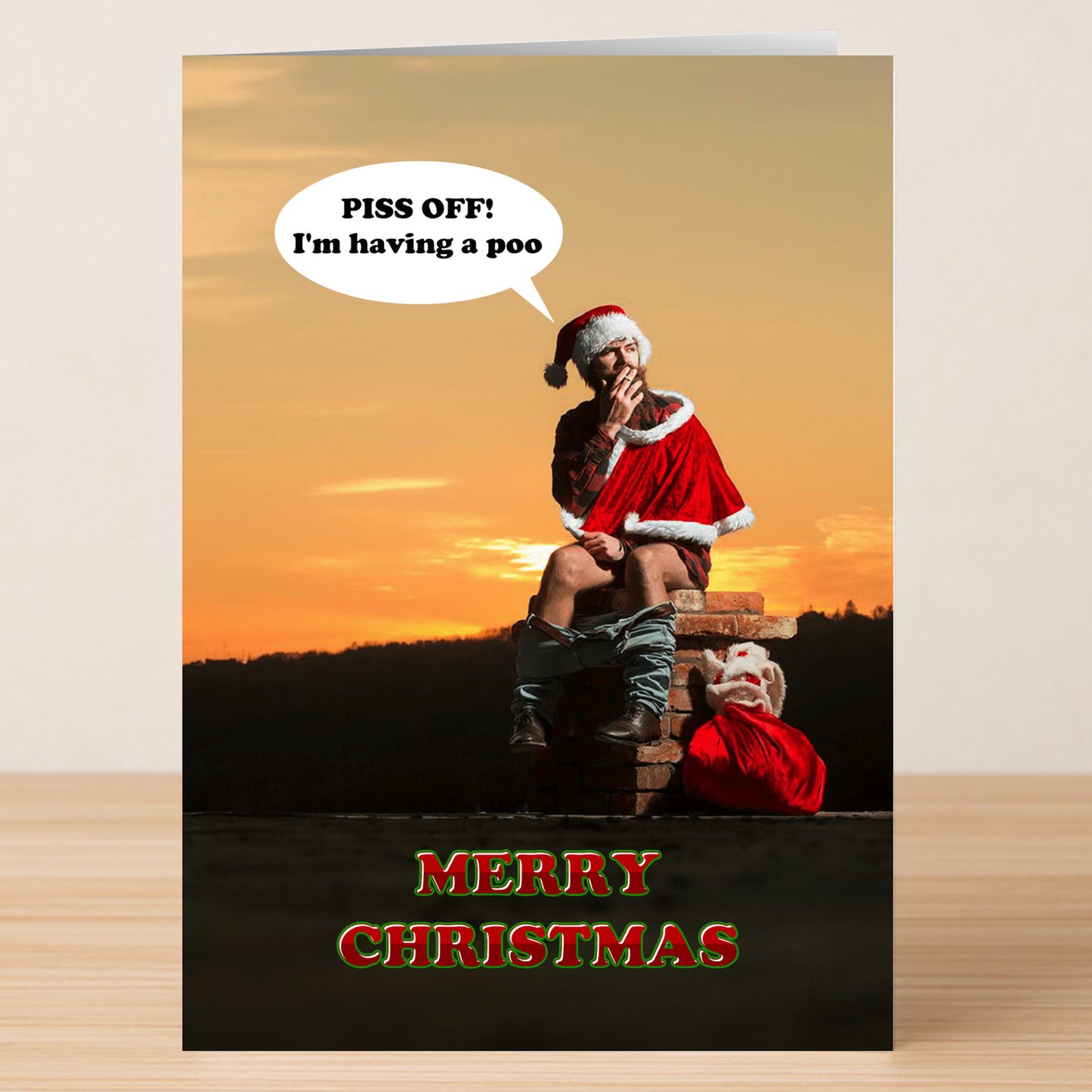 The Piss Off Rude Christmas Card by Twisted Gifts features Santa on an outdoor toilet at sunset, pants down, saying "PISS OFF: I'm having a poo." Bold text below reads "MERRY CHRISTMAS," making for a hilariously cheeky holiday card.