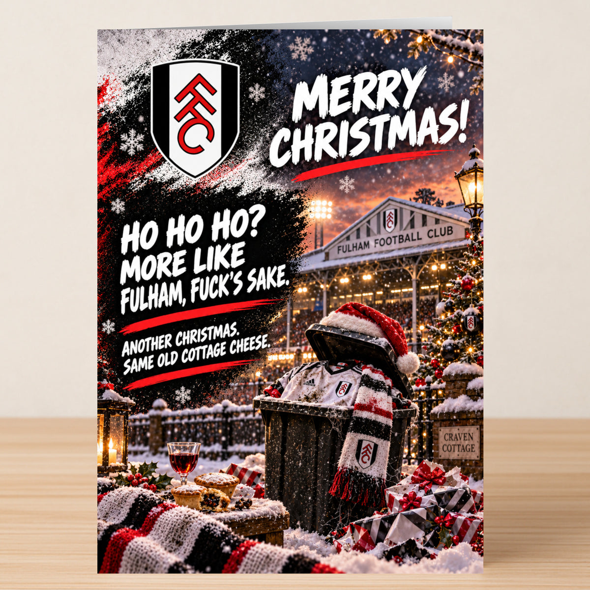 A Fulham – Funny Christmas Card by Twisted Gifts depicting a Fulham FC jersey and scarf in a trash can outside Craven Cottage, inscribed with a rude message about the team’s performance.