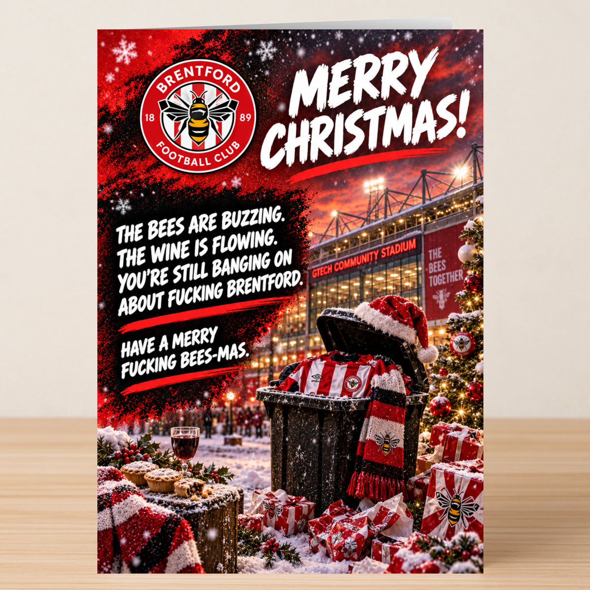 A Brentford – Funny Christmas Card featuring the Brentford FC logo and stadium, with the text: “The bees are buzzing. The wine is flowing. You’re still banging on about fucking Brentford. Have a merry fucking bees-mas.”