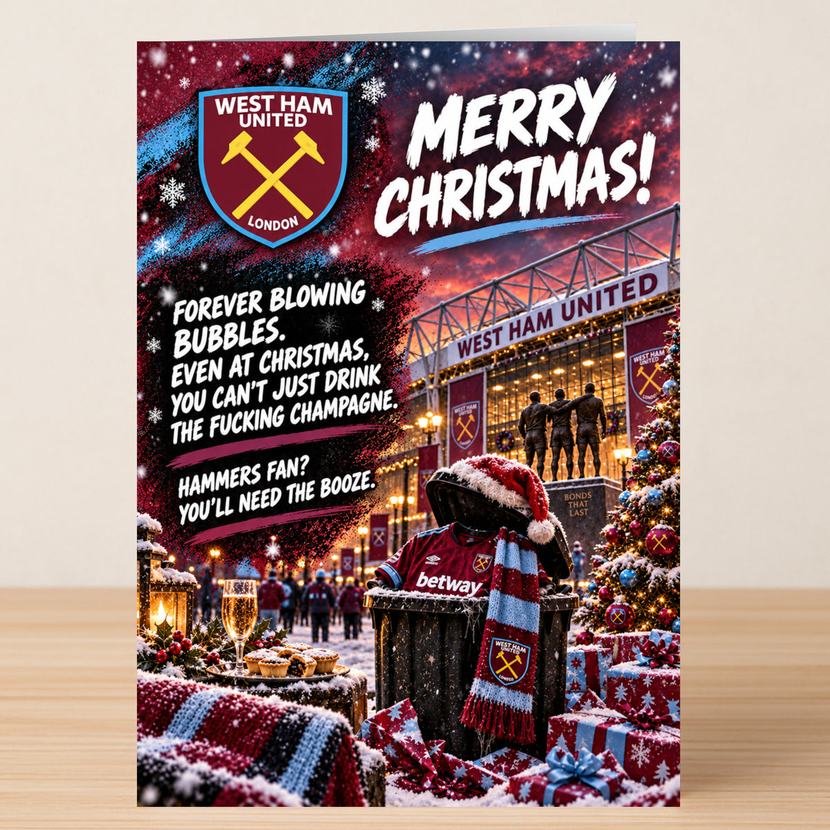 West Ham United – Funny Christmas Card featuring the team logo, a trash can in a Santa hat and scarf, stadium imagery, gifts, and the text: “Merry Christmas! Forever blowing bubbles.”
