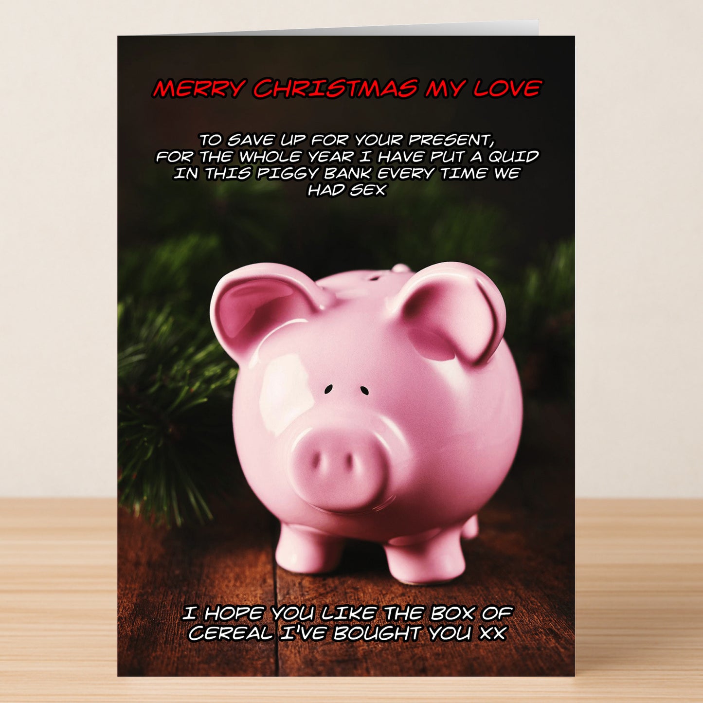 The Cereal Funny Christmas Card by Twisted Gifts features a pink piggy bank and a cheeky message about saving money and splurging on cereal—a hilarious way to spread festive cheer this season.