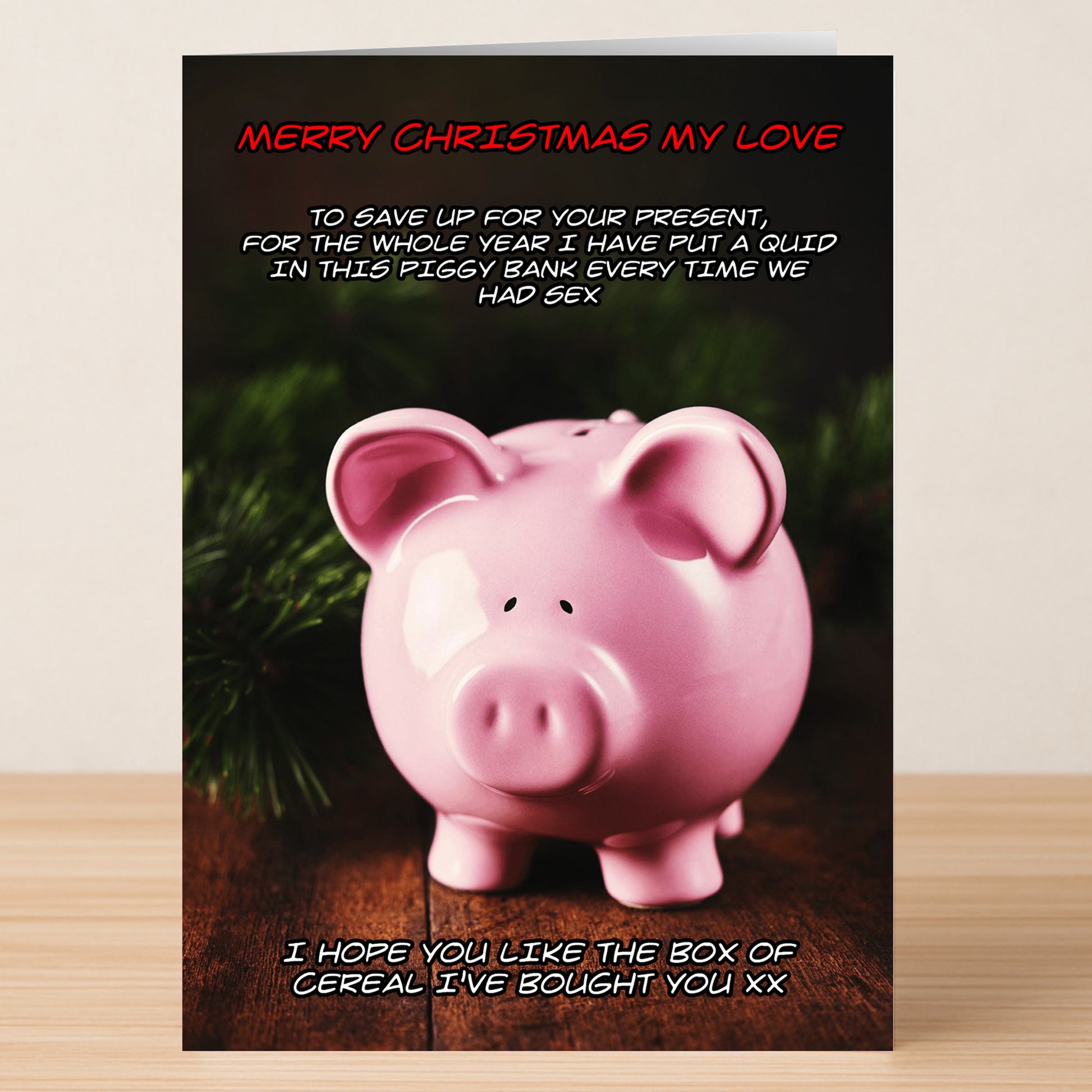 The Cereal Funny Christmas Card by Twisted Gifts features a pink piggy bank and a cheeky message about saving money and splurging on cereal—a hilarious way to spread festive cheer this season.
