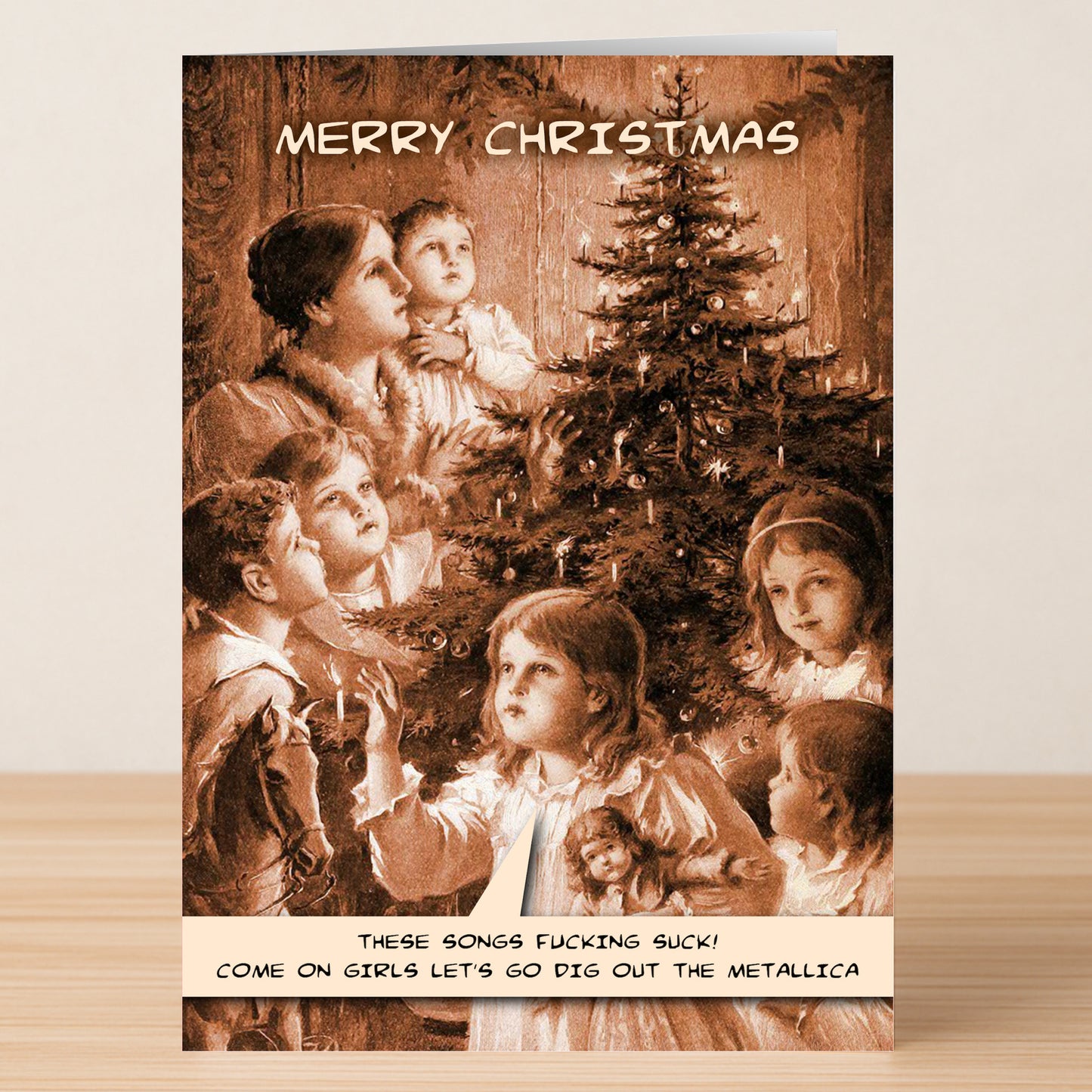 A witty Victorian-style Metallica Funny Christmas Card by Twisted Gifts features a family around a tree saying, "These songs fucking suck! Come on girls, let’s go dig out the Metallica." Perfect for adding holiday cheer with attitude.