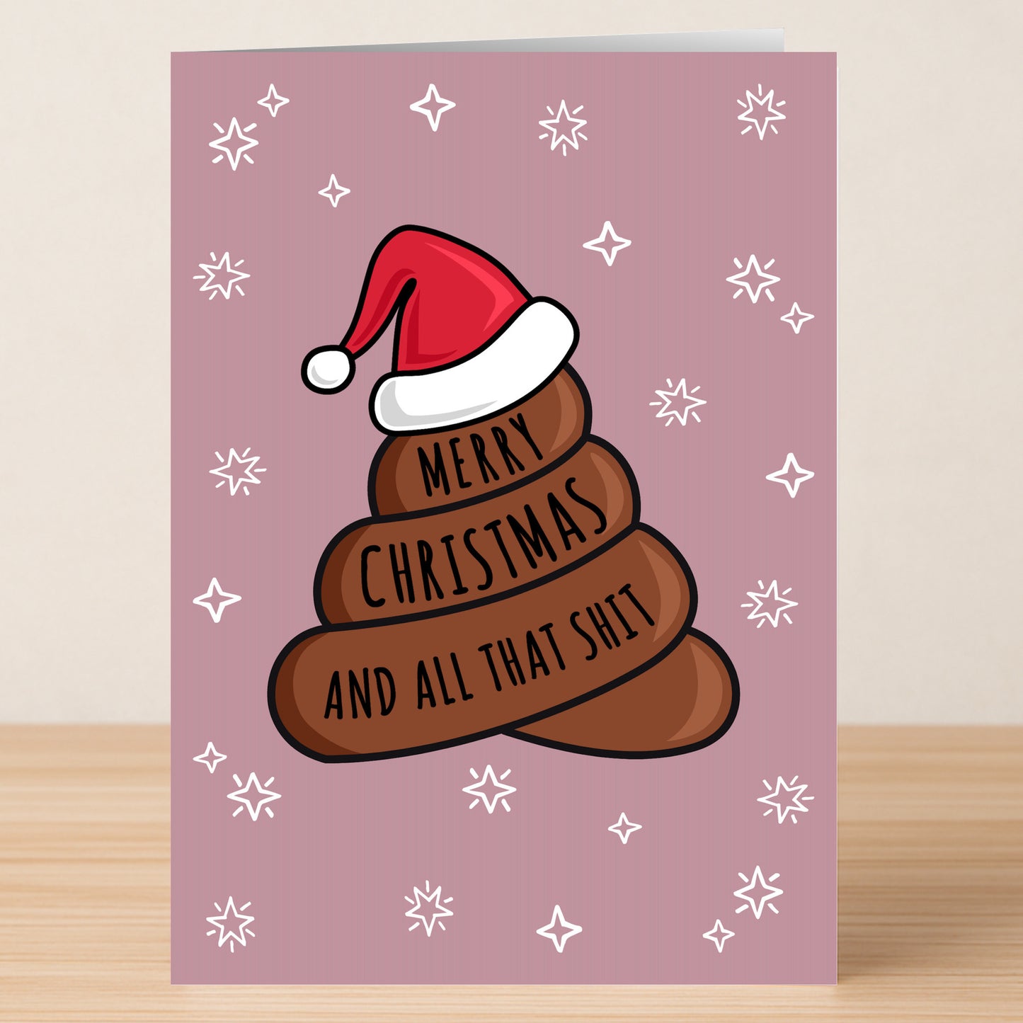 The All That Shit Rude Christmas Card by Twisted Gifts features a cartoon poop emoji in a Santa hat with "Merry Christmas and all that shit" on a pink, snowflake background—perfect for cheeky festive cheer.