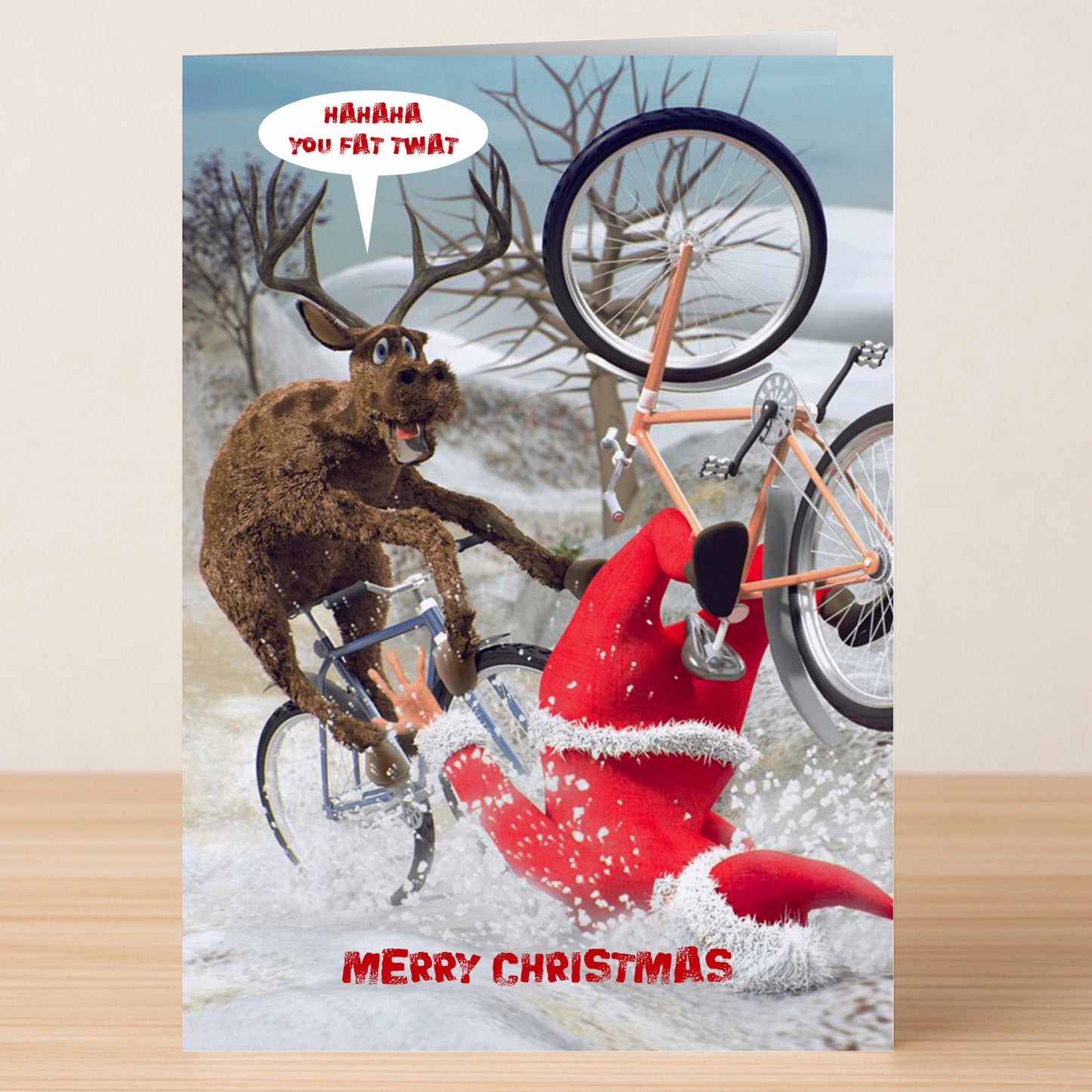 A cartoon reindeer mocks Santa falling off a bicycle in the snow, saying "Hahaha you fat twat." This Fat Twat Funny Christmas Card by Twisted Gifts features a witty message with the caption "Merry Christmas" below.