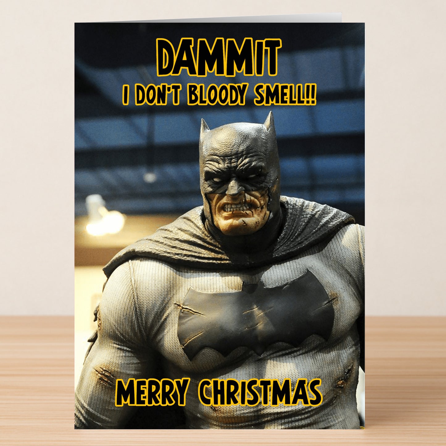The Batman Smells Funny Christmas Card by Twisted Gifts features a grumpy Batman and the bold yellow phrase "DAMMIT I DON'T BLOODY SMELL!! MERRY CHRISTMAS"—a hilarious choice for spreading unexpected holiday cheer.