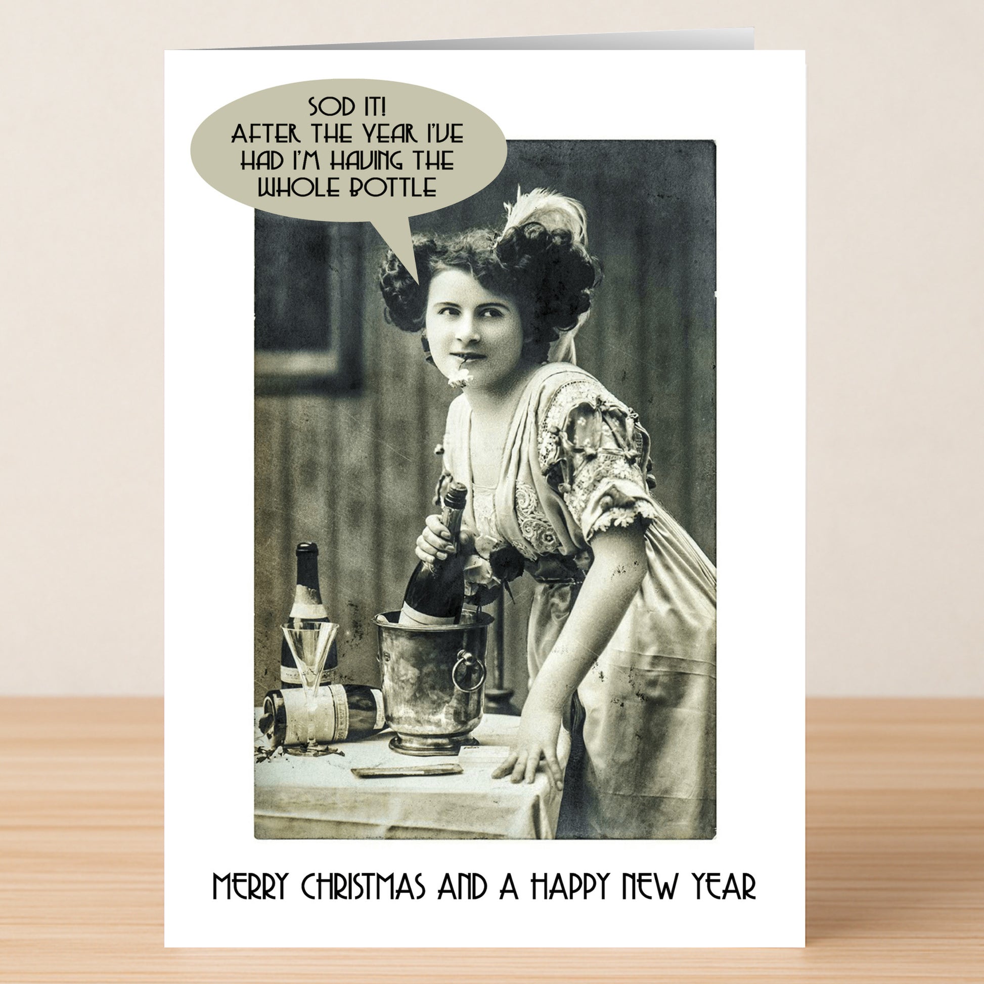 The Whole Bottle Funny Christmas Card by Twisted Gifts features a vintage woman with wine and the message "Merry Christmas and a Happy New Year"—a perfect way to share festive humor this holiday season!.