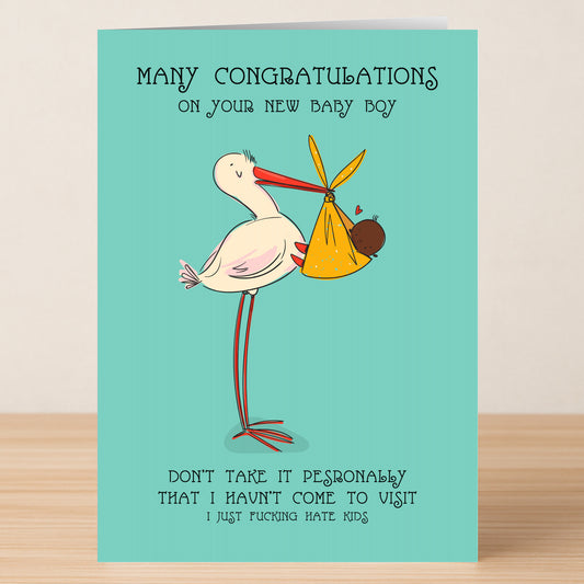 Twisted Gifts’ Personally Boy Insulting Congratulations Card playfully congratulates new parents with a cartoon stork and baby boy, adding quirky humor about not visiting thanks to a funny dislike for kids.