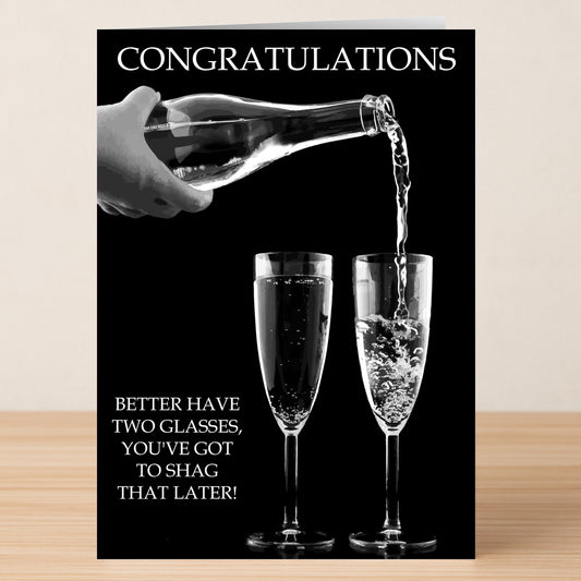 The Two Glasses Insulting Congratulations Card from Twisted Gifts features a hand pouring champagne into one of two glasses with the message: "CONGRATULATIONS" and "Better have two glasses, you've got to shag that later!.