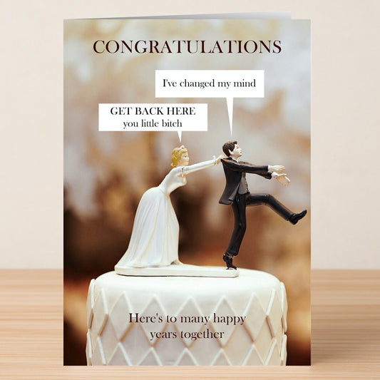 The Changed My Mind Funny Congratulations Card by Twisted Gifts features a wedding cake topper with a bride pulling back a reluctant groom and speech bubbles: “I’ve changed my mind” and “GET BACK HERE you little bitch.”.