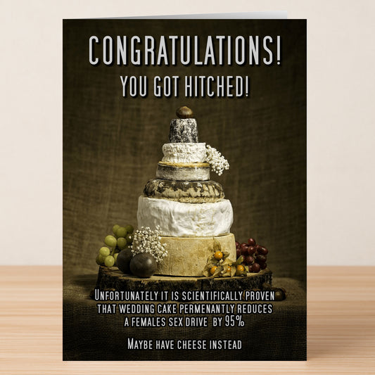 The Sex Drive Funny Congratulations Card by Twisted Gifts features a cheese wheel wedding cake and grapes with the message: "Congratulations! You got hitched! It’s proven wedding cake reduces a female's sex drive by 95%. Maybe have cheese instead.