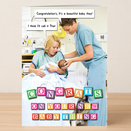 A nurse hands a newborn to a parent in bed. Colorful block letters on the Baby Thing Funny Congratulations Card by Twisted Gifts read, "CONGRATS ON YOUR NEW BABY THING," with witty speech bubbles for new parents.
