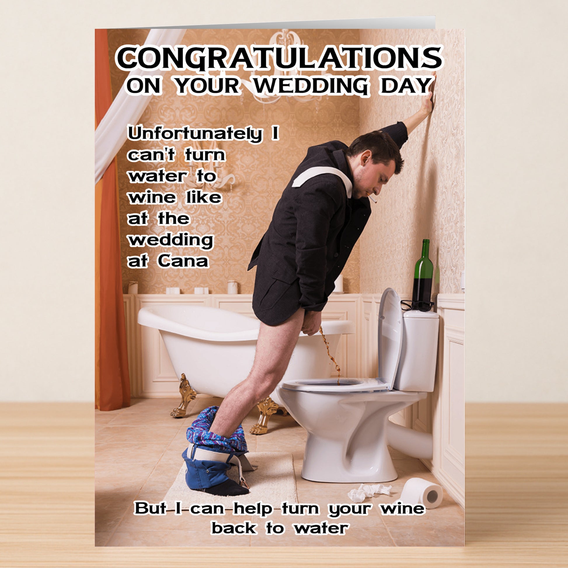 A man in a suit with pants down pours wine into a toilet—a classic “Wine To Water” scene—features humorous wedding congratulations on the Wine To Water Funny Congratulations Card by Twisted Gifts.