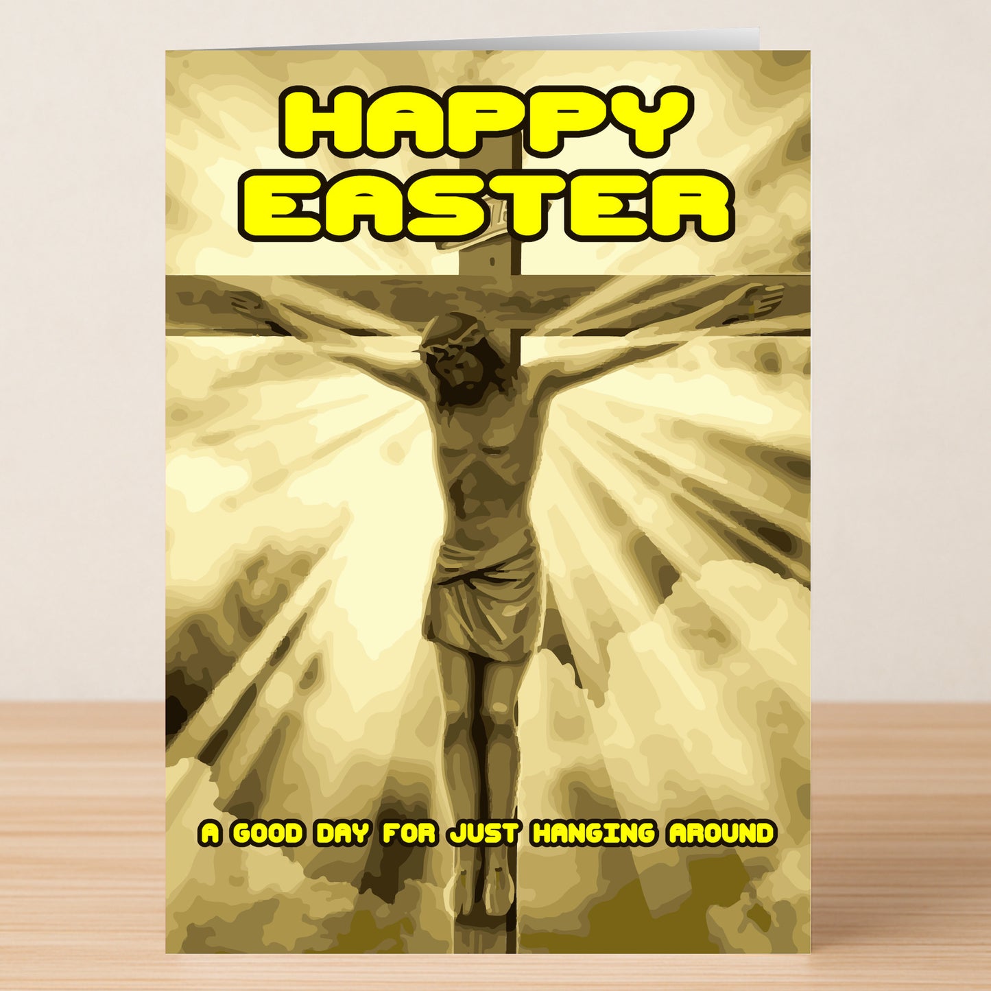 The Hanging Around Funny Easter Card by Twisted Gifts features Jesus on the cross with rays of light and the witty text: "Happy Easter" and "A good day for just hanging around.