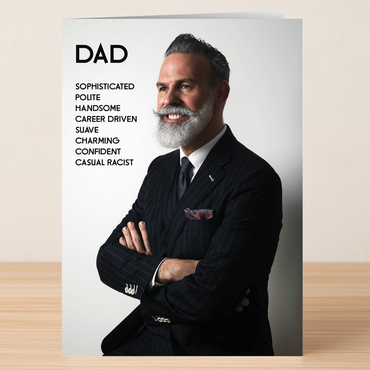 Share a laugh with the Suave Insulting Father's Day Card from Twisted Gifts: a stylish gray-haired man smiles boldly, arms folded, as his positive traits are listed—culminating in the ultimate suave insult for Father's Day.